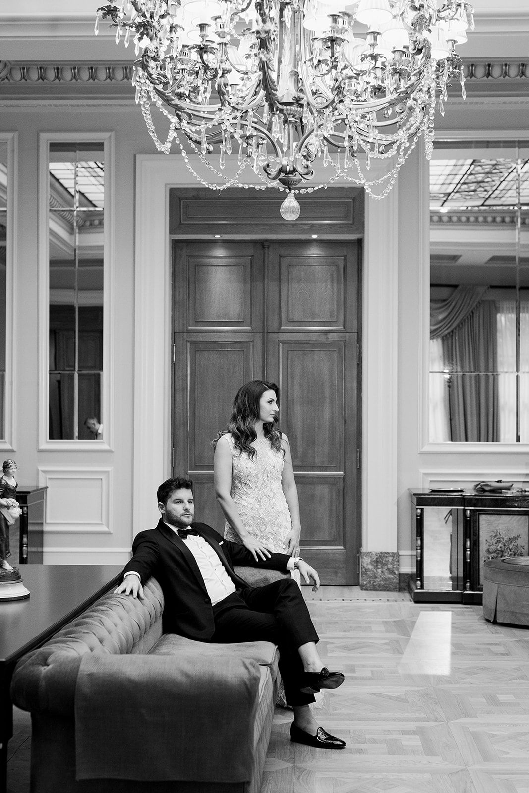 bride and groom sitting in an elegant hotel living room