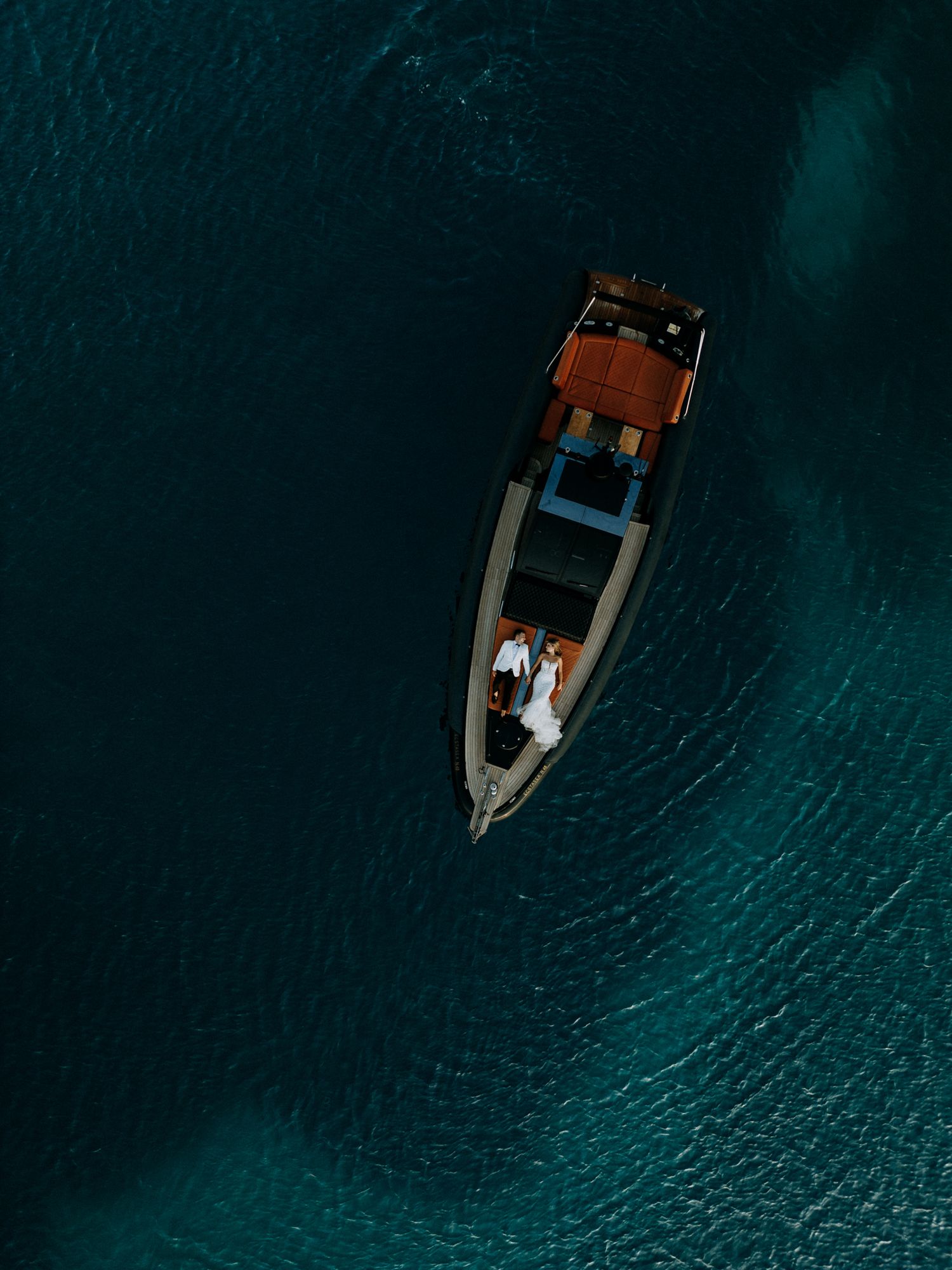 aerial capture of a cruise boat where the bride and groom sits together