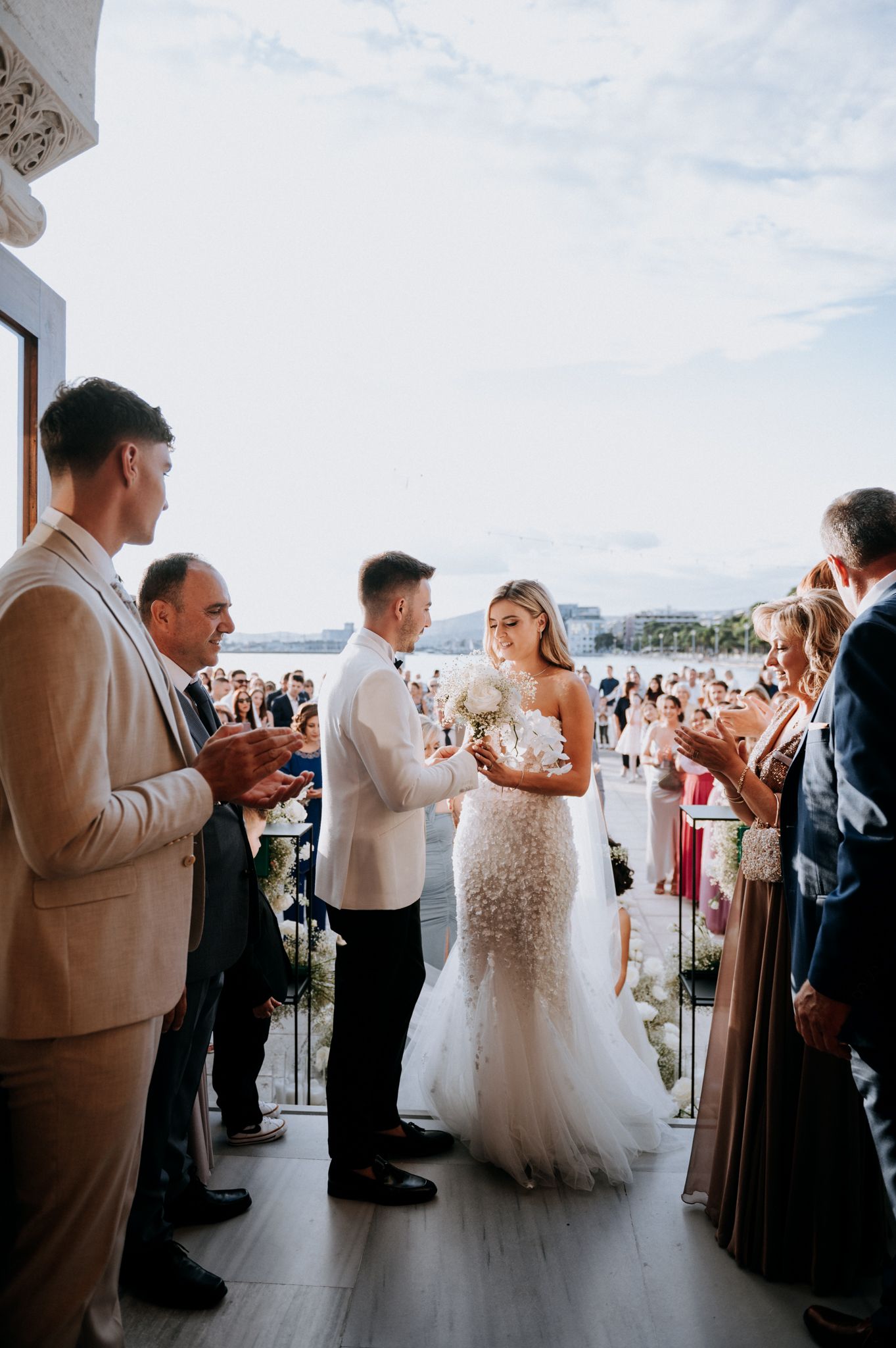 bride and groom meeting each other outside the church before the wedding