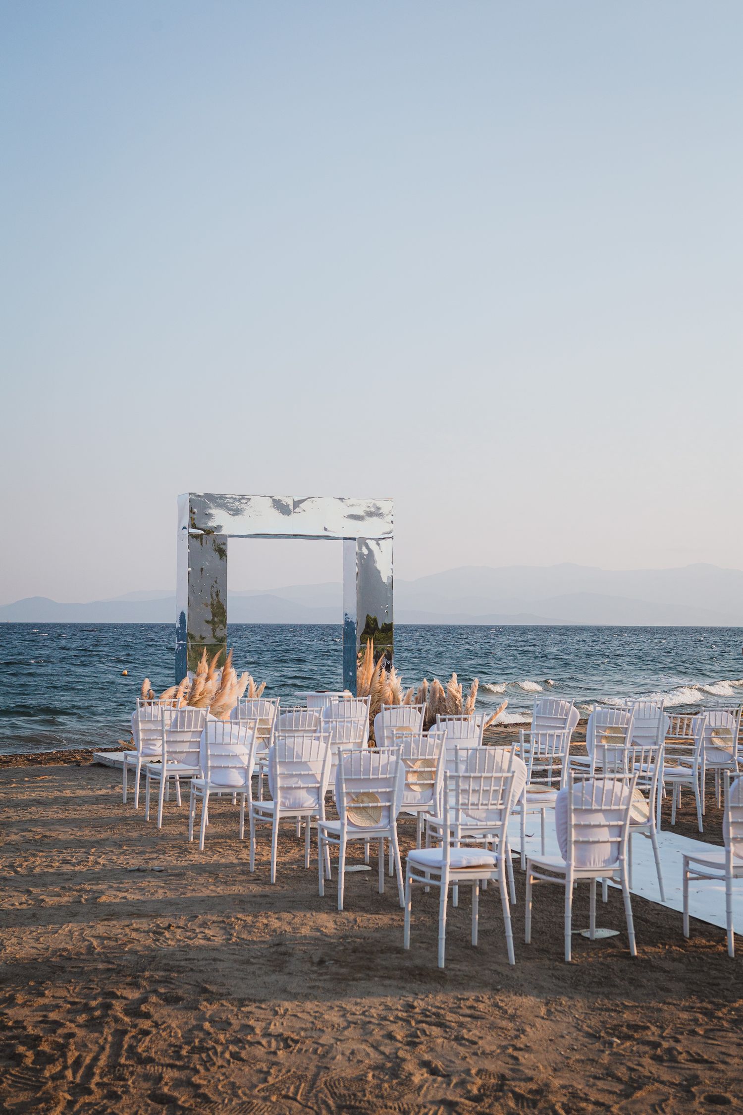 beach wedding with mirror arch