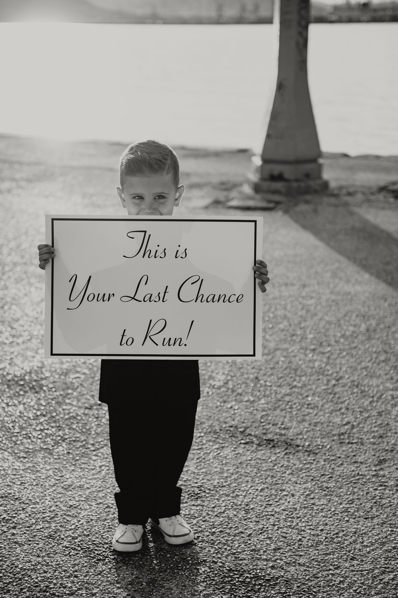 a little boy holding a funny sign saying 