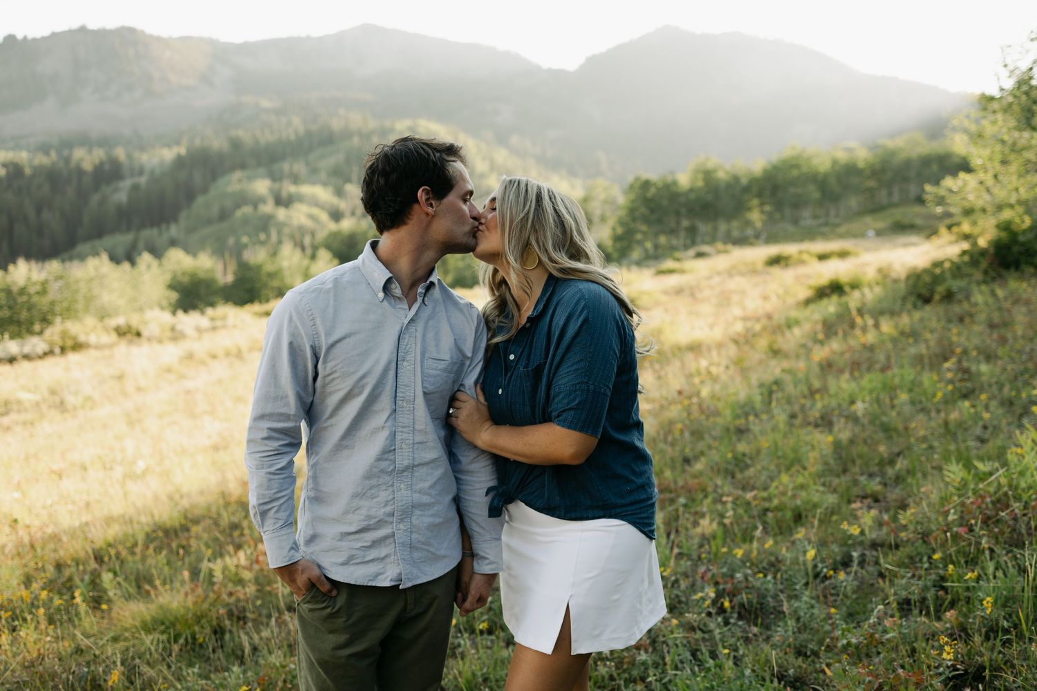 Series of intimate moments shared between couple on mountain trail during golden hour.
