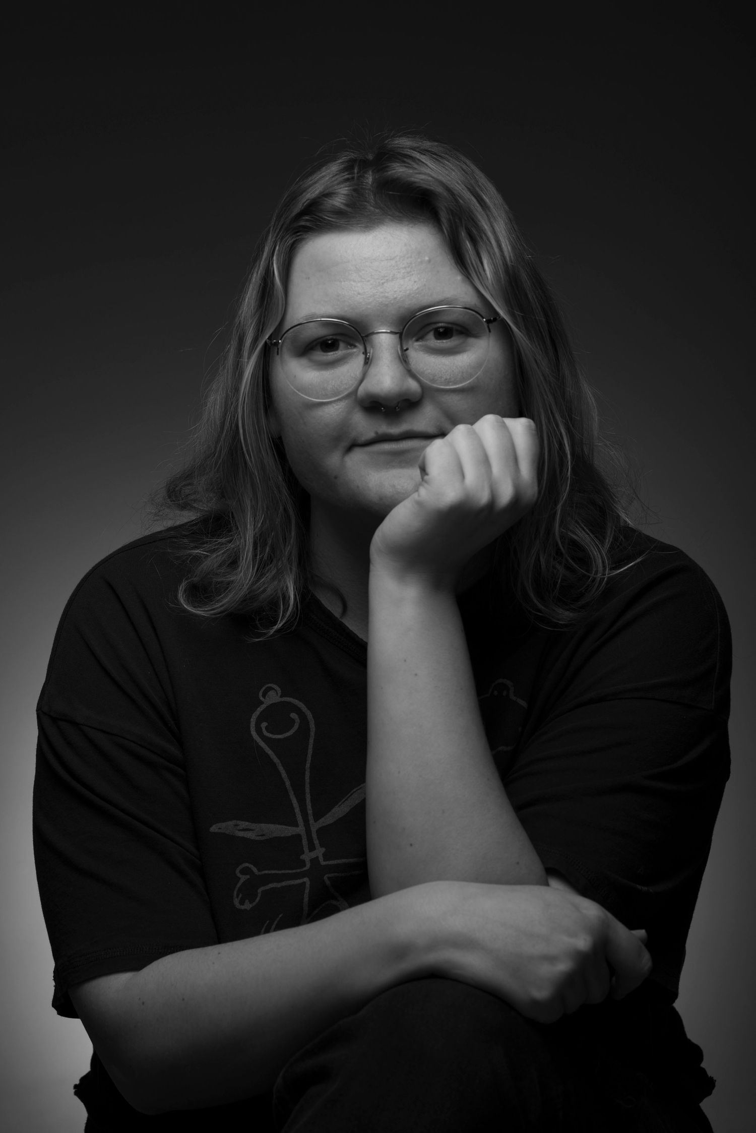 A series of black and white portraits showing a person in a dark shirt against a shadowy background.