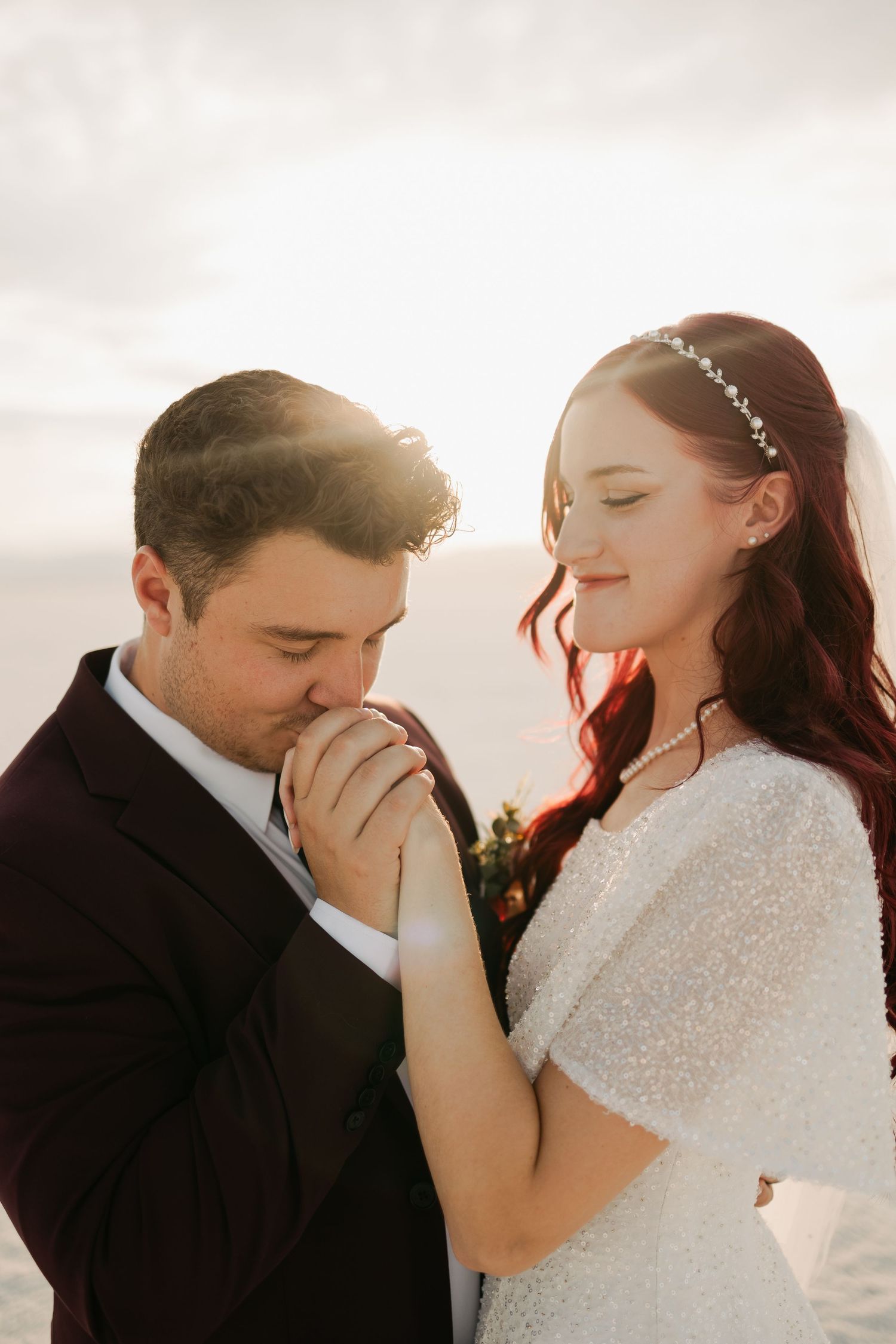 Intimate wedding portrait session with couple in formal attire against soft lighting.
