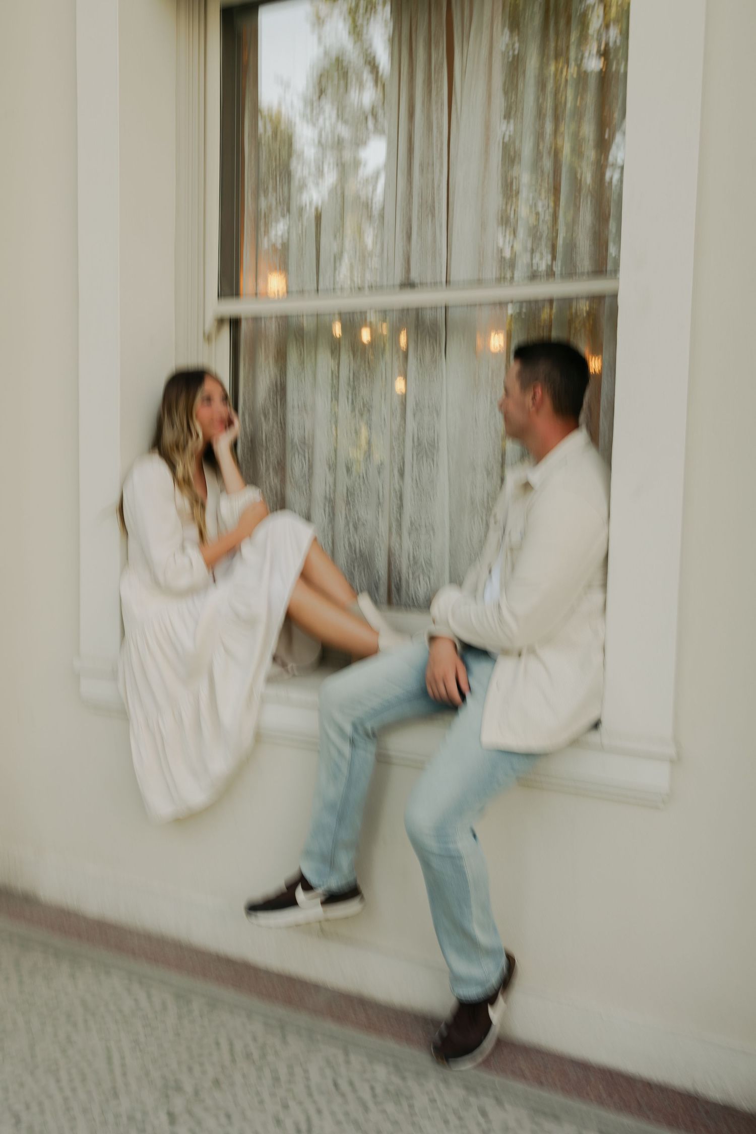 Series of playful interaction shots near large window with light curtains.