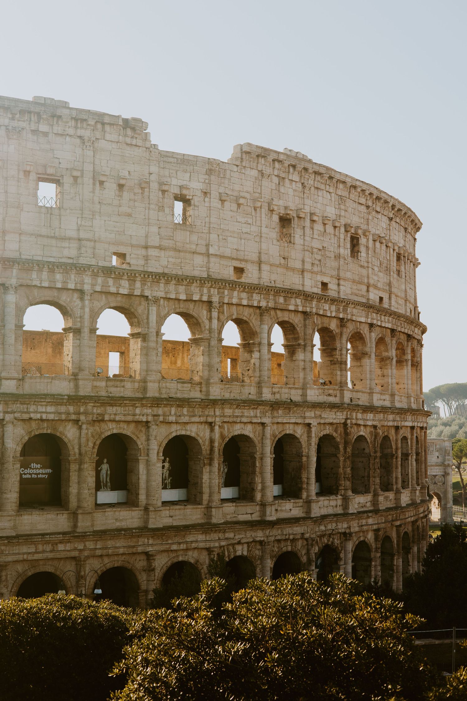The ancient Roman Colosseum stands majestically in Rome, Italy, showcasing its iconic arched facade at golden hour.