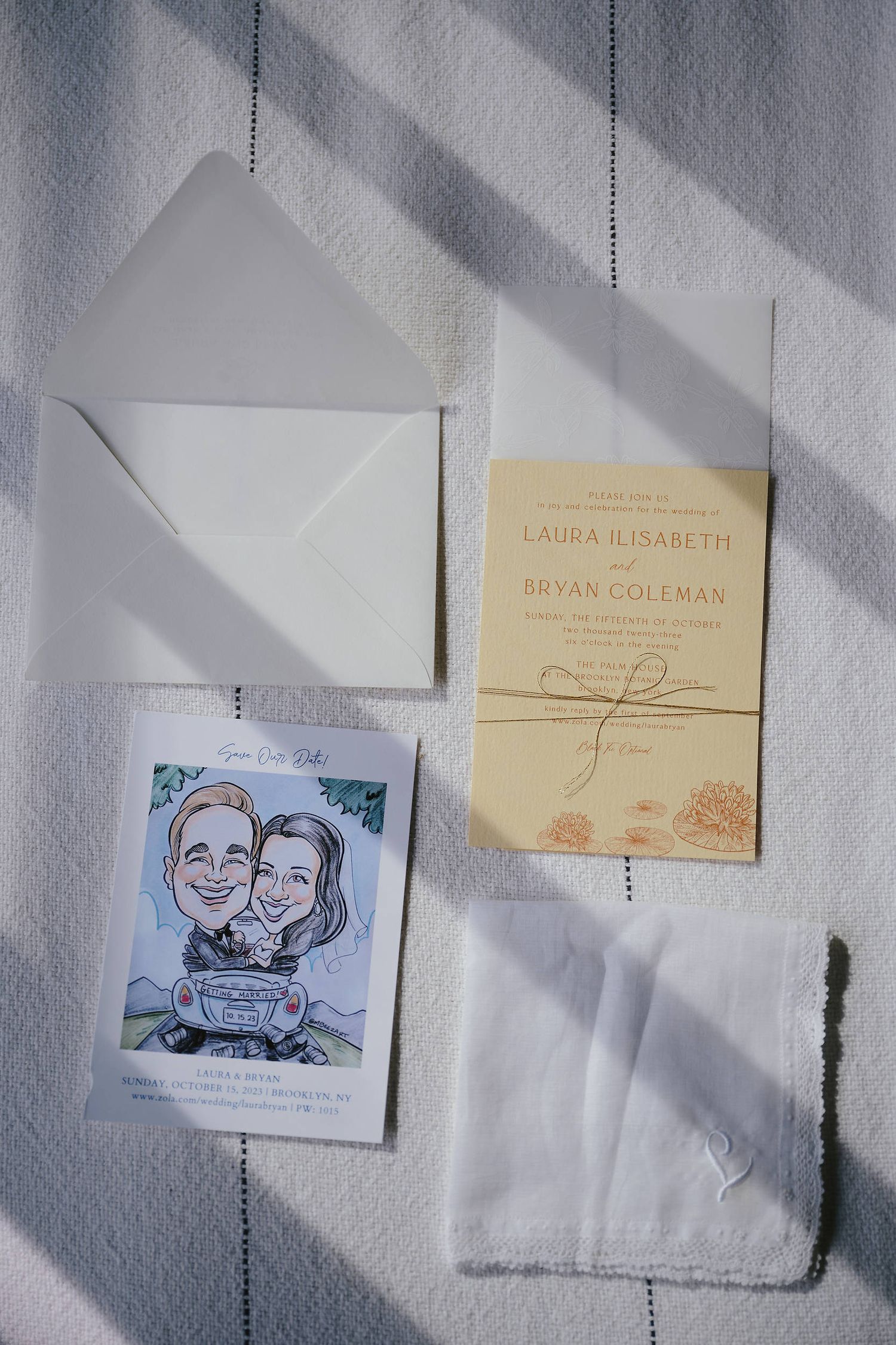 Wedding invitation suite with envelopes, a custom illustrated card and beige invitation laid on white surface with shadows.