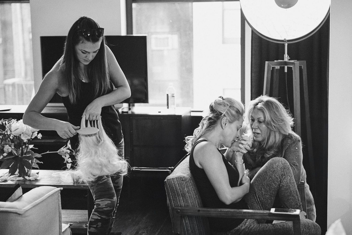 Behind the scenes black and white photo of people preparing in a salon setting.
