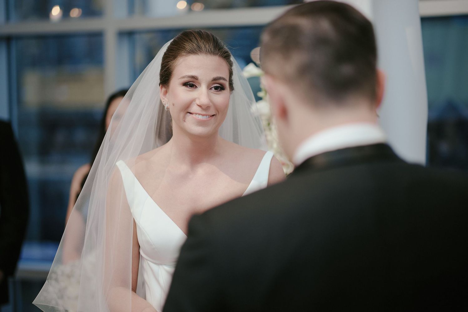An intimate wedding ceremony moment capturing bride and groom exchanging vows under soft lighting.