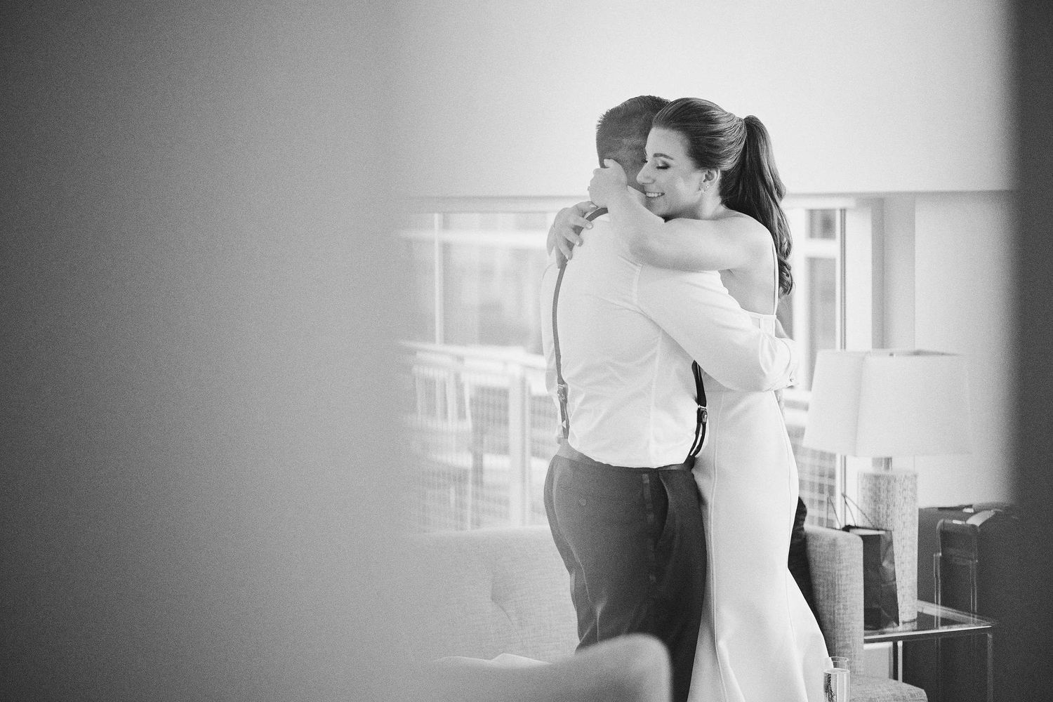 Black and white photograph of couple embracing in an intimate moment during a dance.