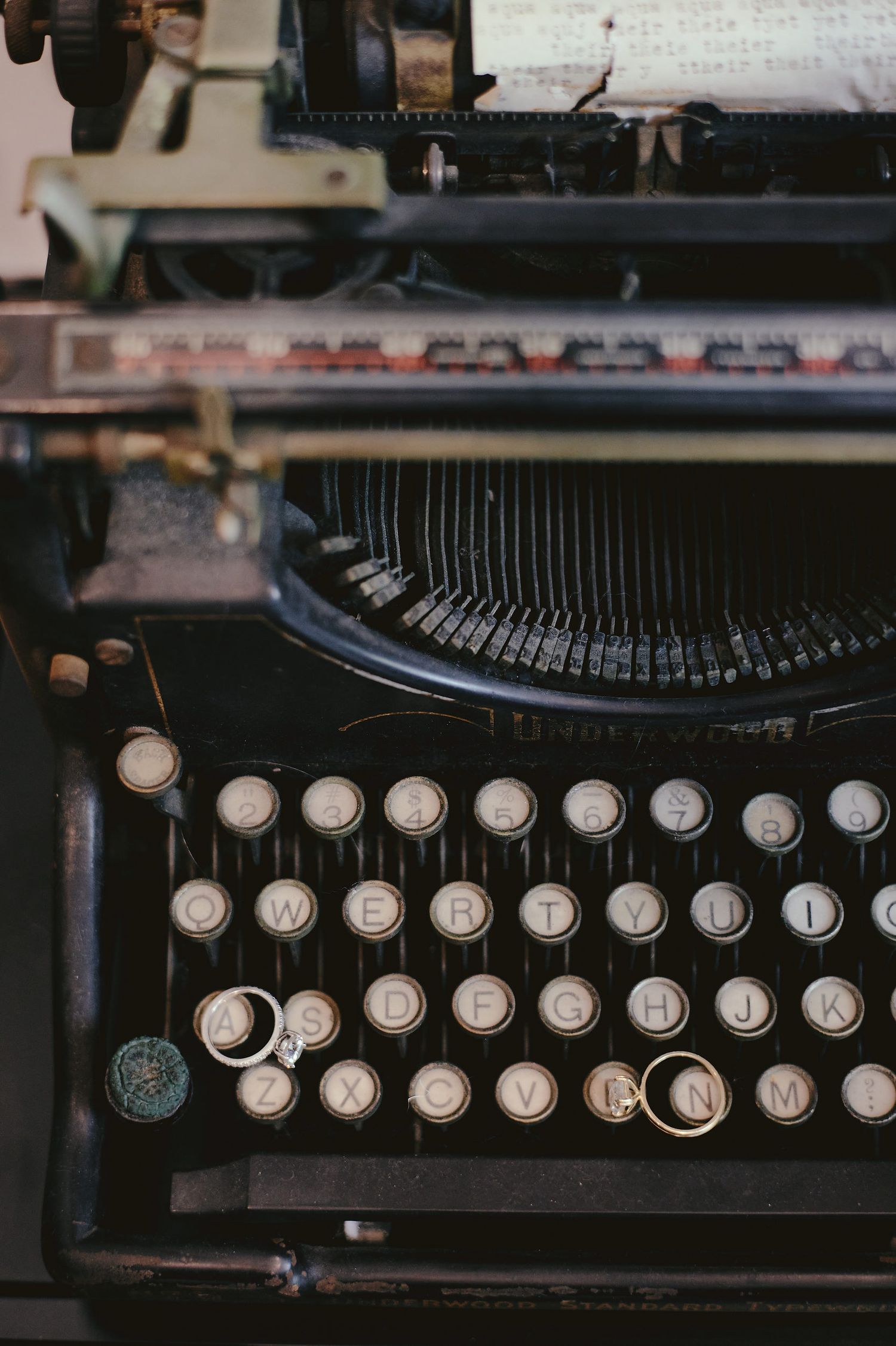 Close-up view of vintage typewriter keys and type bars showing mechanical details in muted tones.