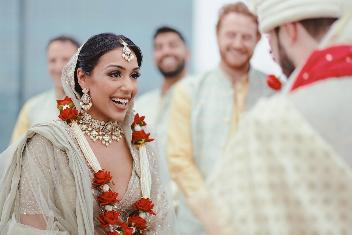 A joyful wedding ceremony with decorative floral garlands and traditional Indian wedding attire.