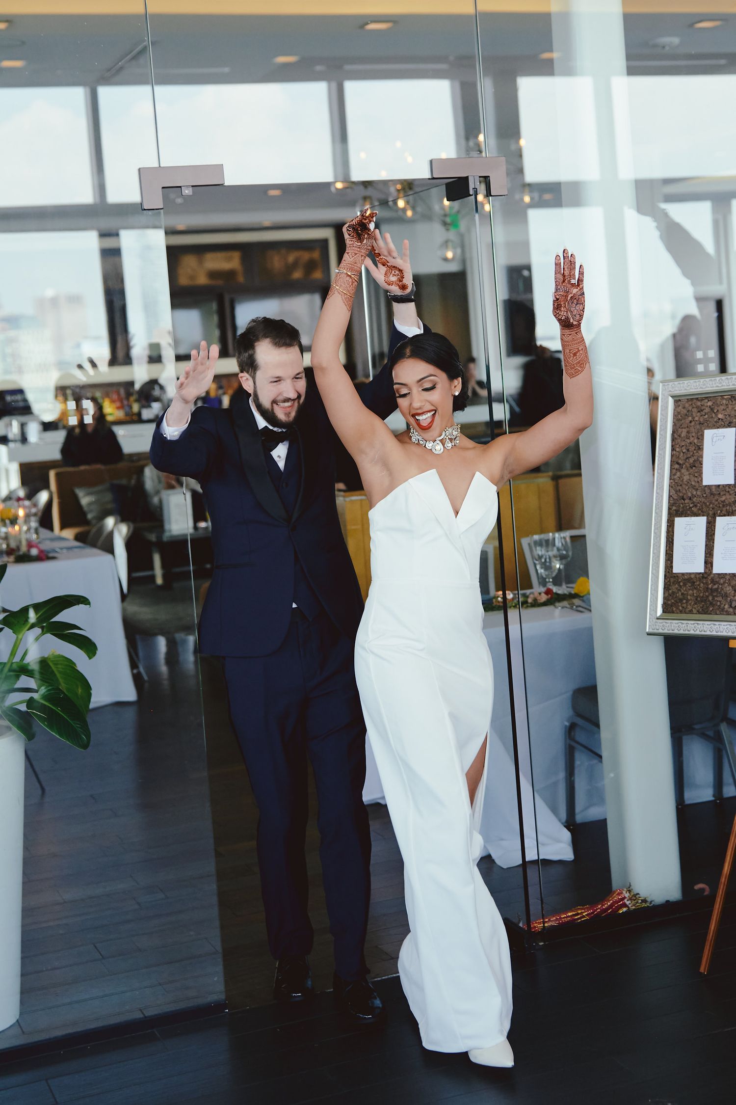 Newlyweds celebrate with triumphant entrance dance moves at their modern wedding reception.
