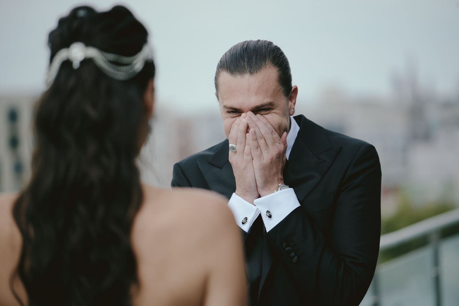 A groom becomes emotional during first look with bride on their wedding day.