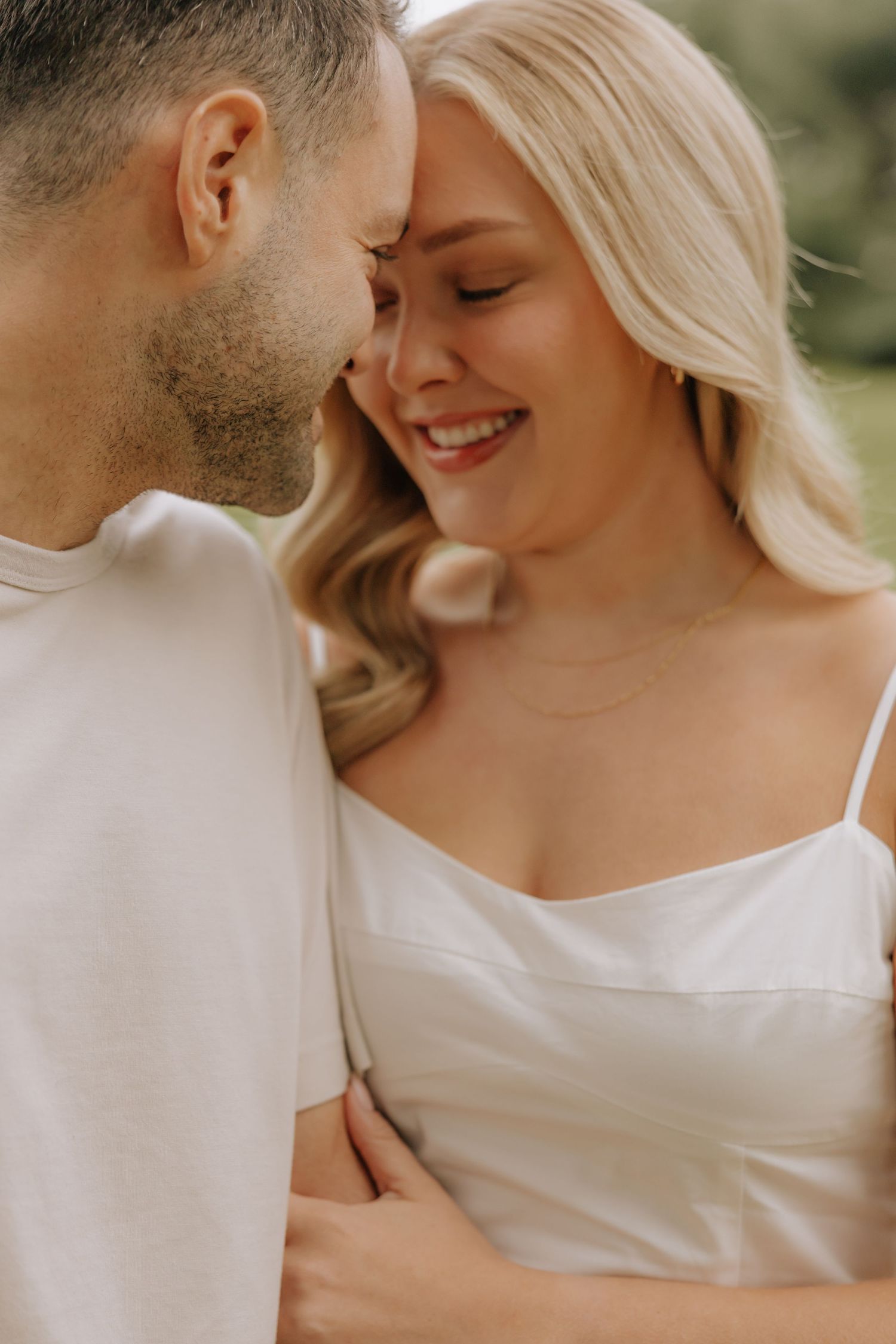 Intimate romantic couple in white clothing share tender moments outdoors in a series of close-up photos.
