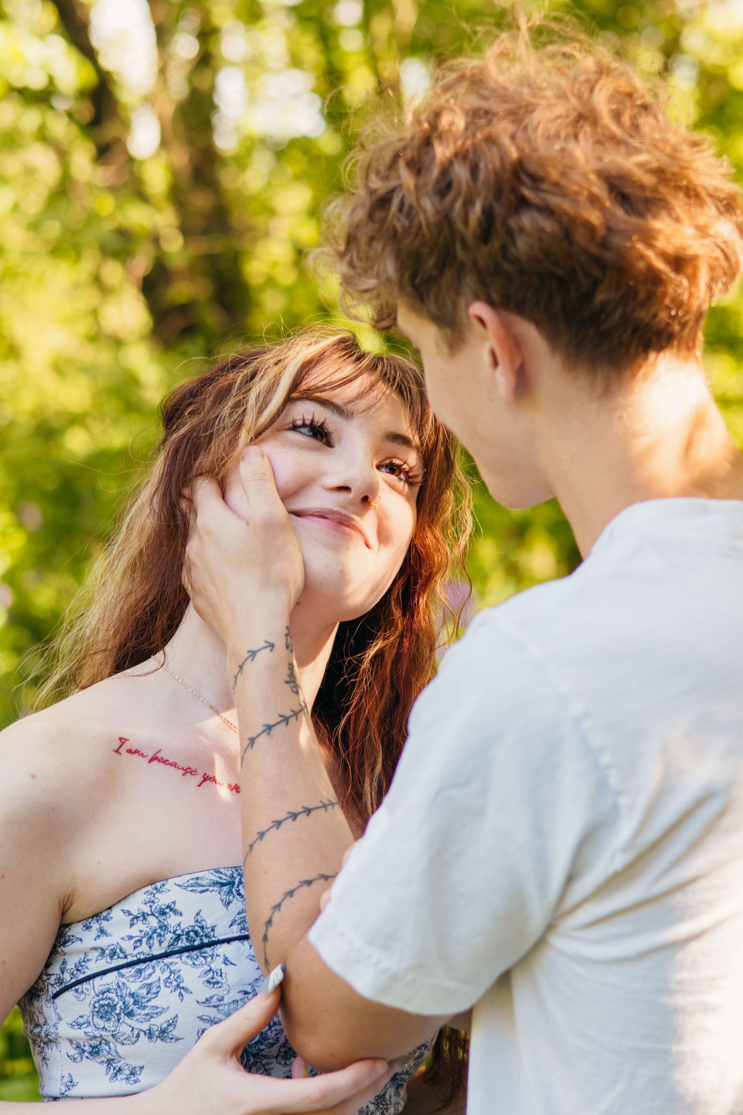 Intimate couple portraits captured in golden sunlight with natural garden backdrop.
