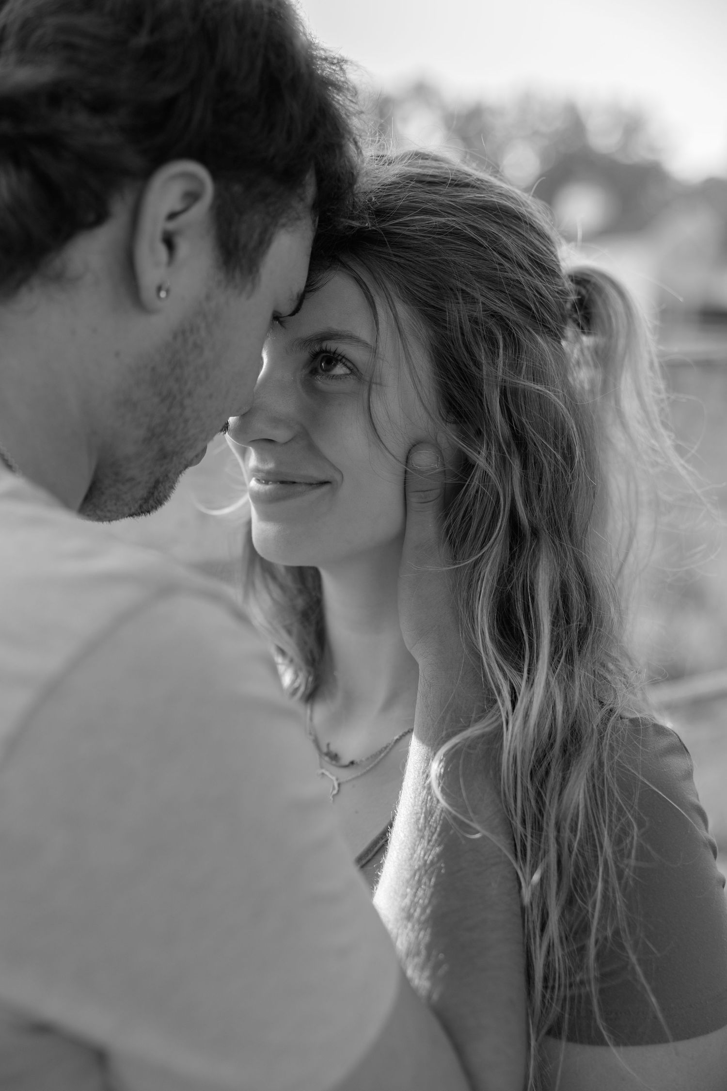 A romantic black and white photo series showing an intimate couple sharing tender moments and kisses.