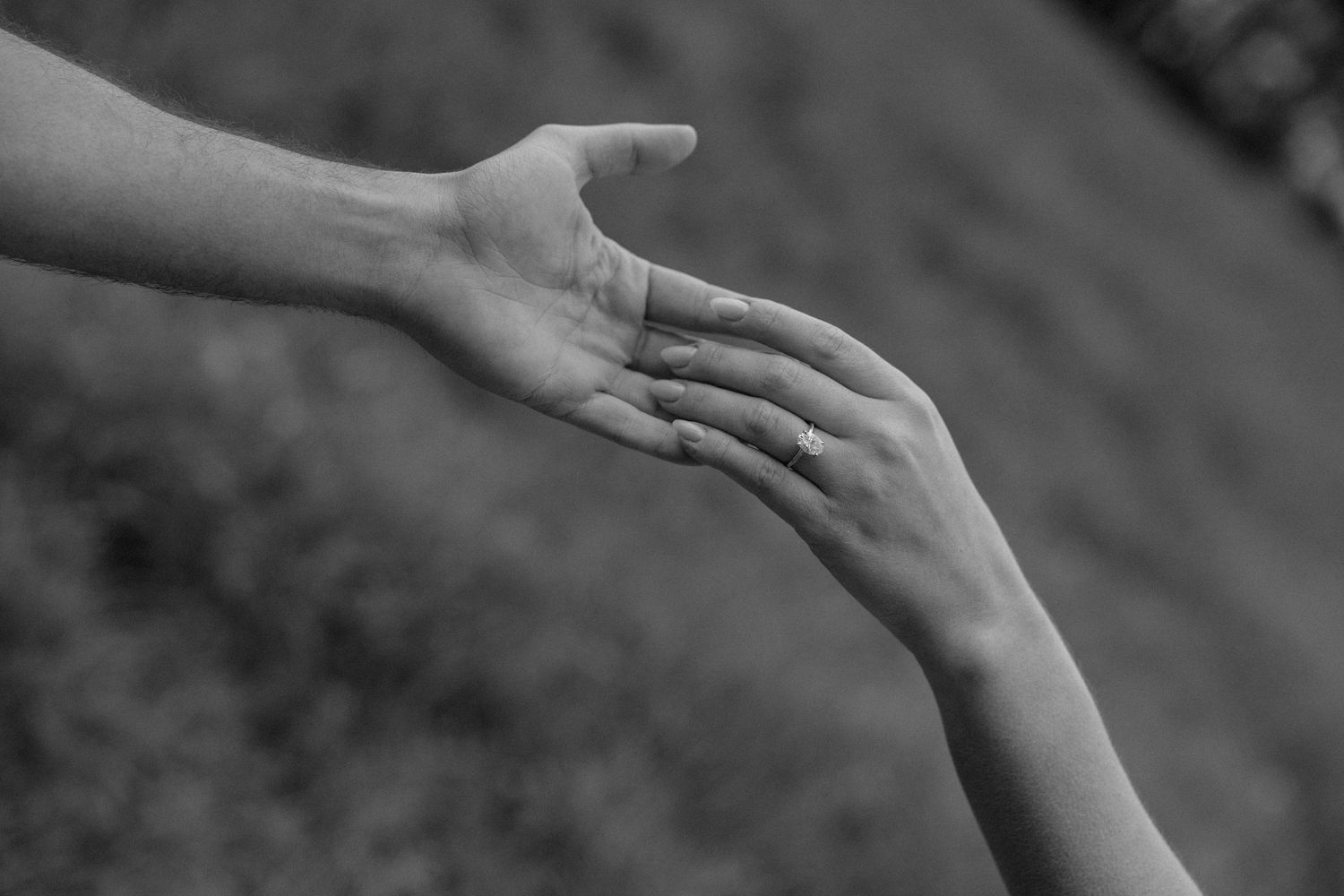 A series of black and white photographs showing hands in different positions and gestures against a dark background.