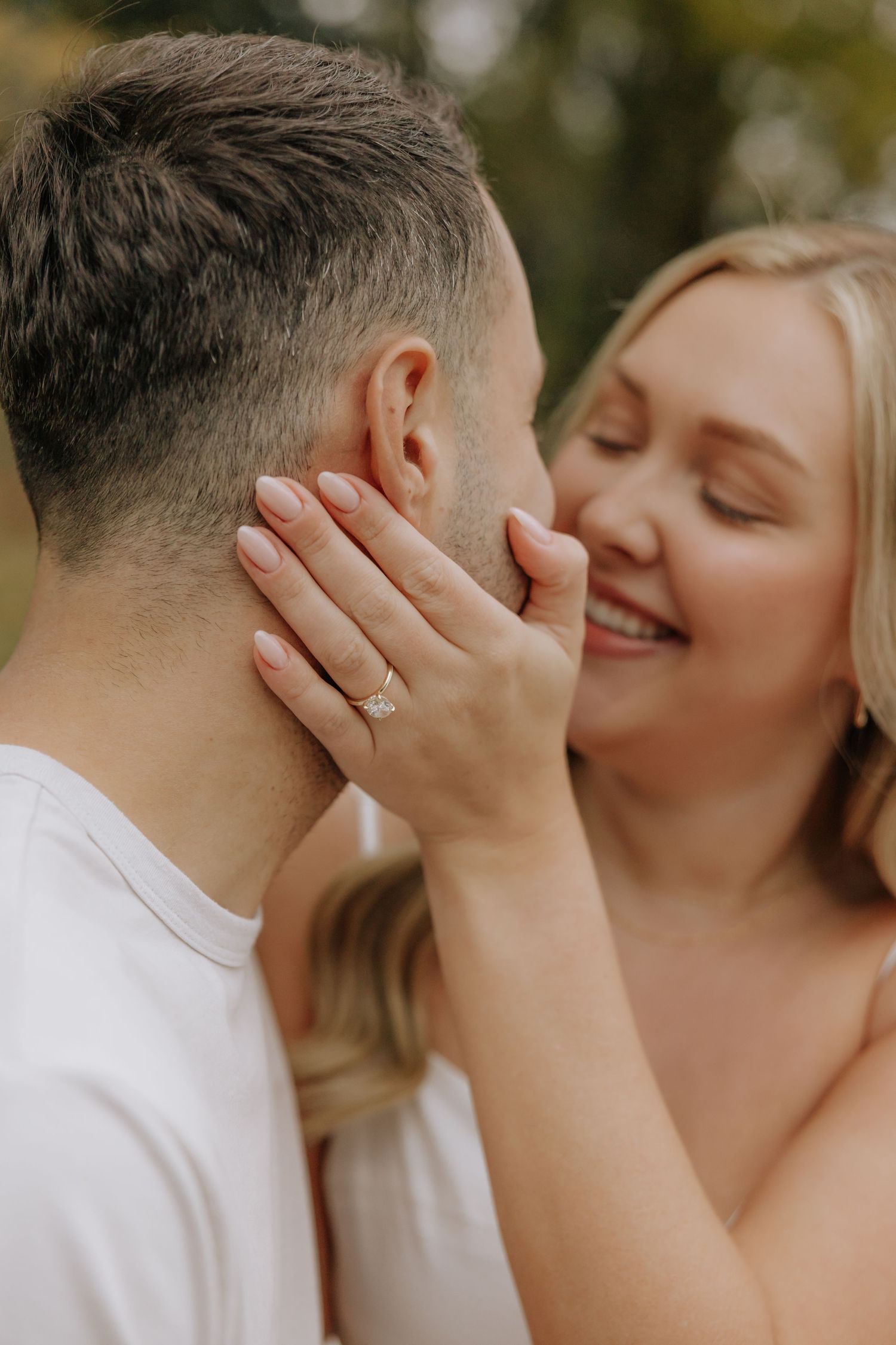 A romantic engagement photo series showing a couple sharing intimate moments and tender kisses outdoors.