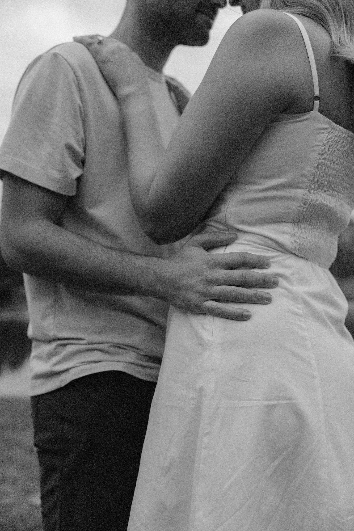 Black and white close-up sequence showing tender embraces and gentle moments.