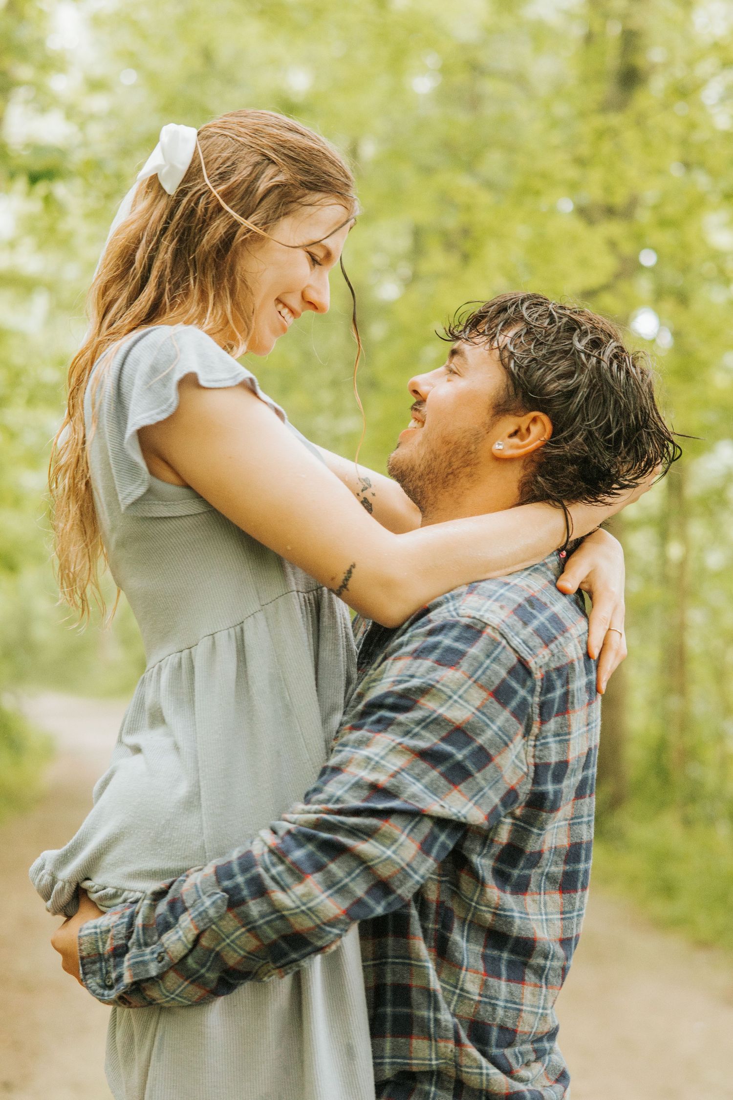 Joyful father-daughter moments captured in a wooded area.