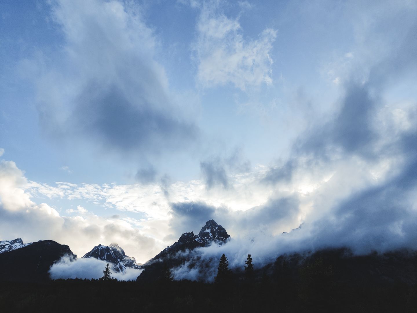 Dramatic cloudy sky panorama with sunlight breaking through.