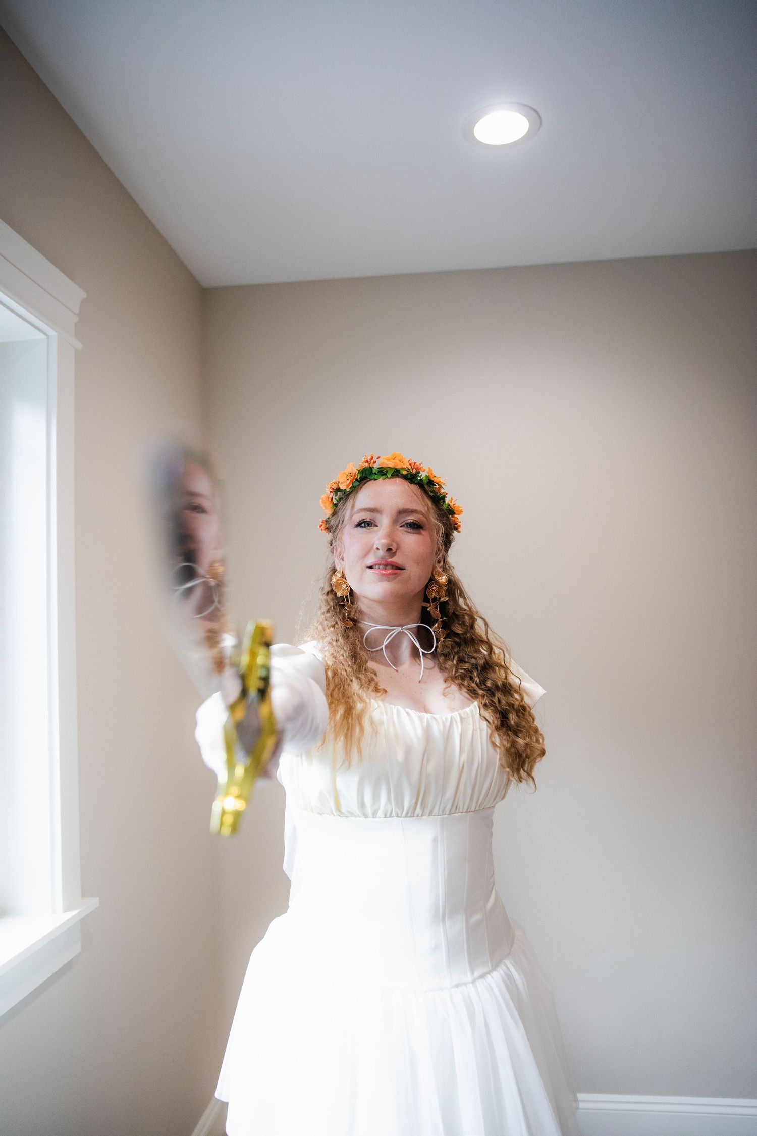 A series of motion shots showing a figure in a white dress twirling and dancing indoors with natural window light.