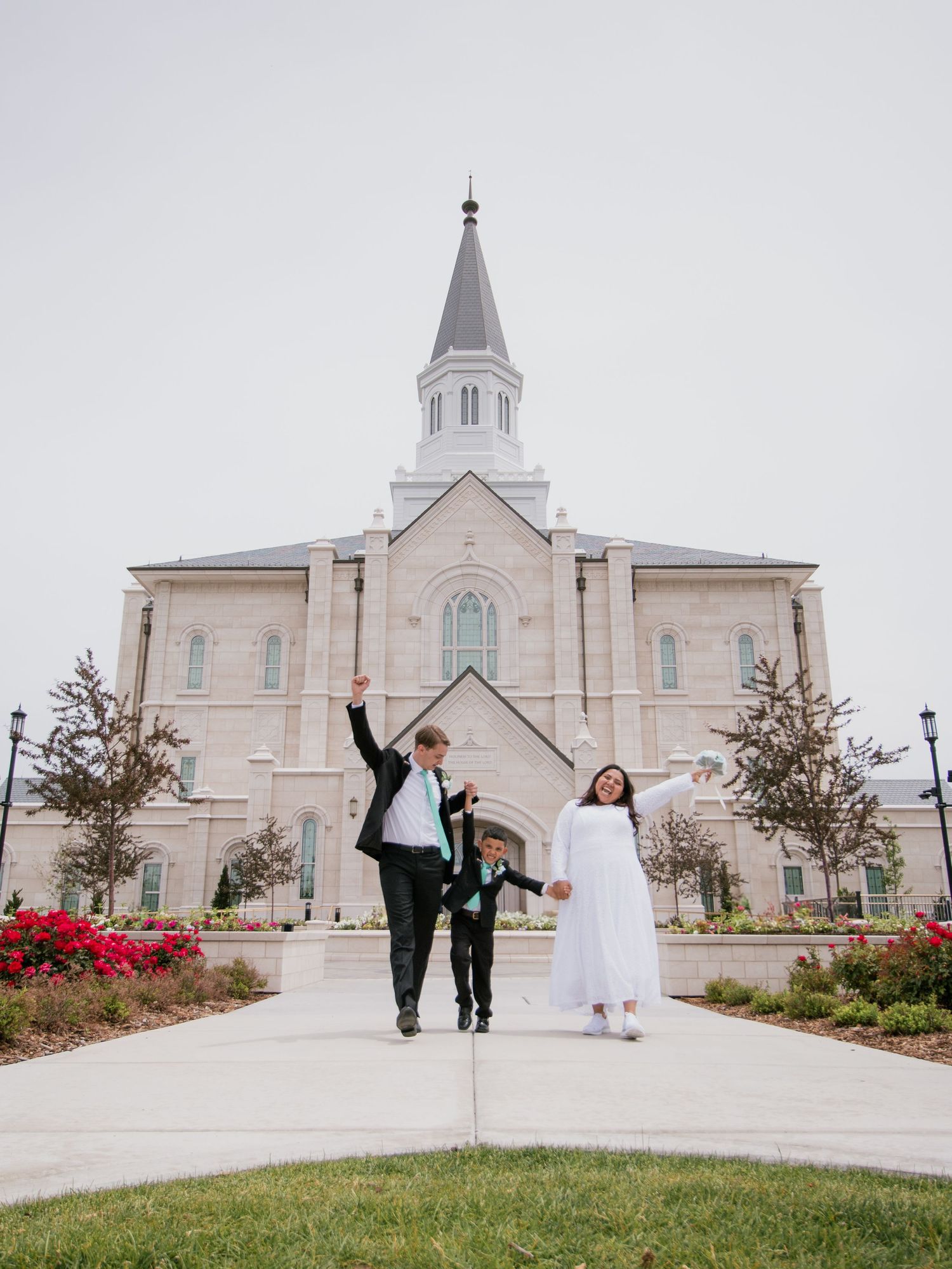 Elegant white church building with spires and walkway on an overcast day.