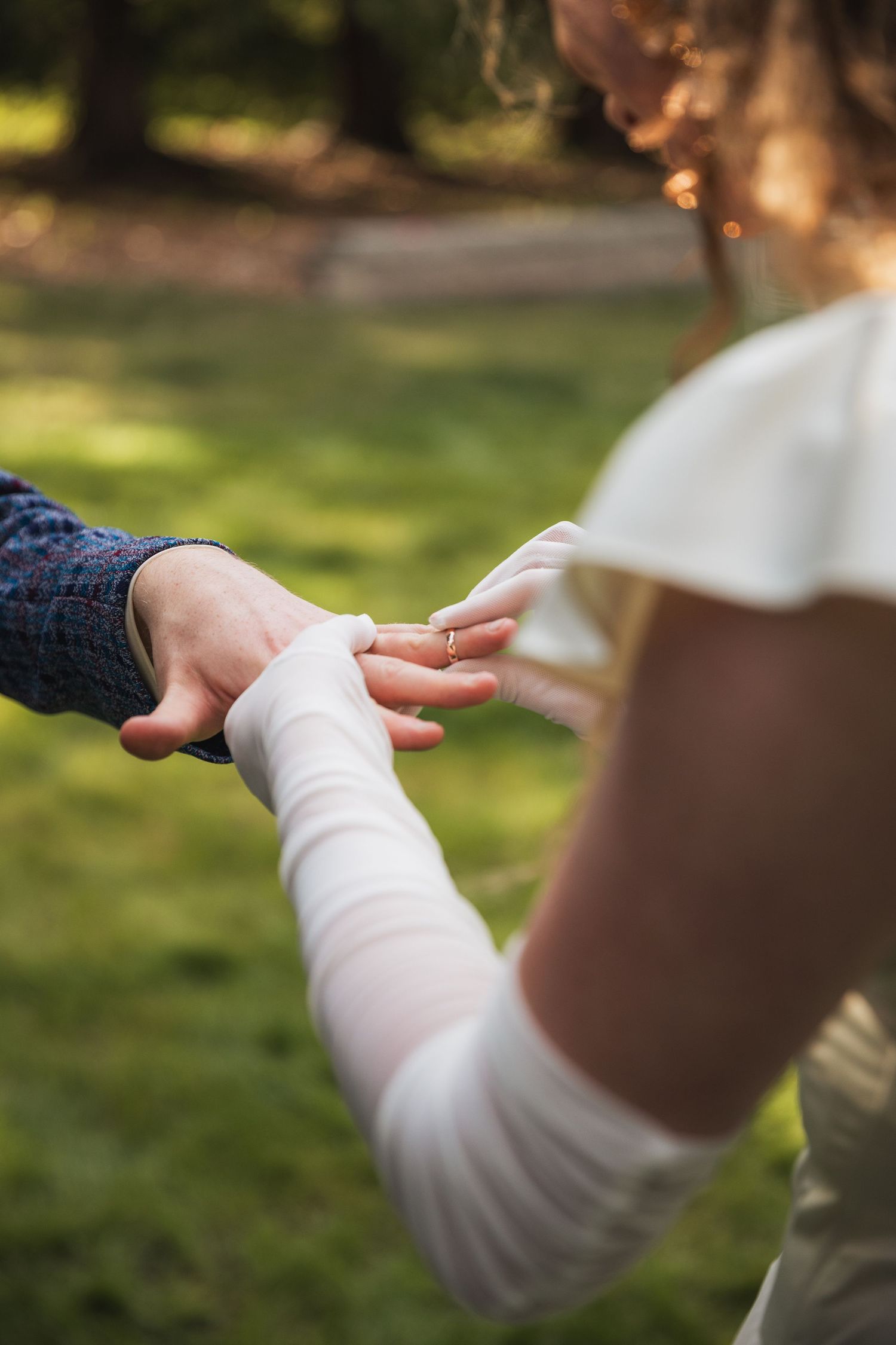 Close-up sequence of hands making graceful dance movements against a sunlit outdoor background.