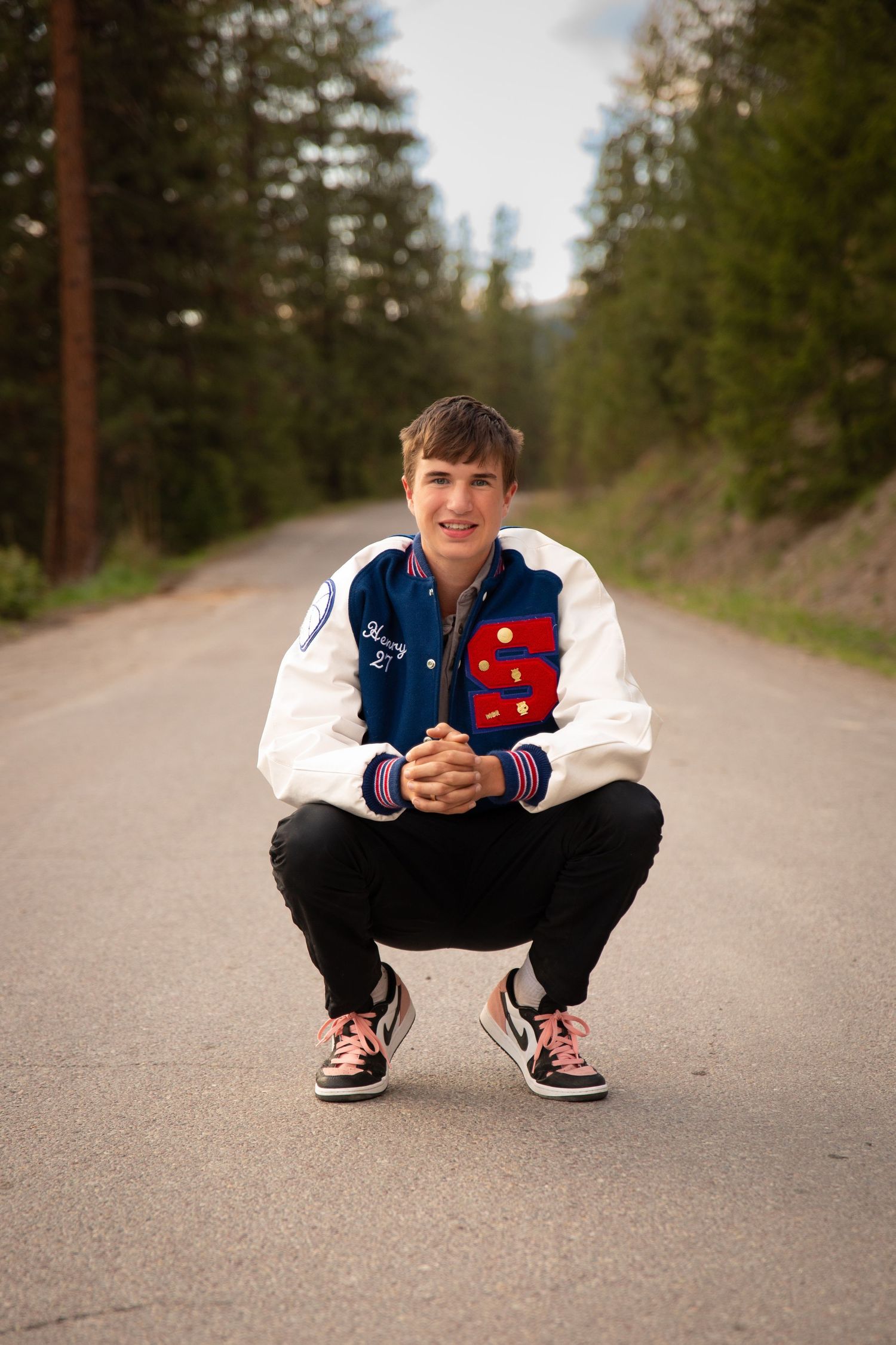 Superior, Mt Graduate Senior Portrait, outside on an empty road wearing letterman jacket
Kayla Sproles Photography 2024