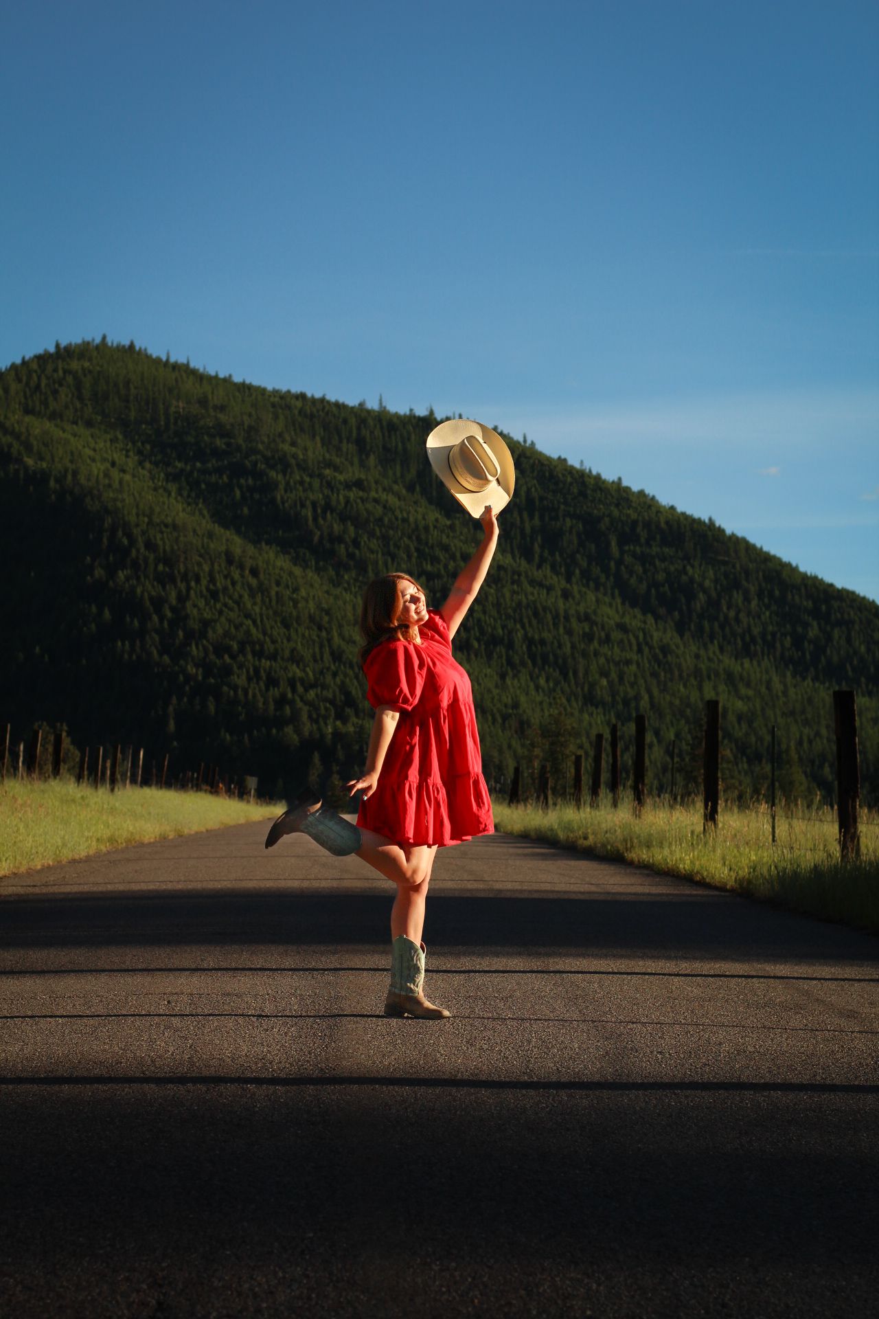 Missoula, Mt Graduate Senior Portrait, blue skies with an empty road, green rolling hills, and valleys 
Kayla Sproles Photography 2024