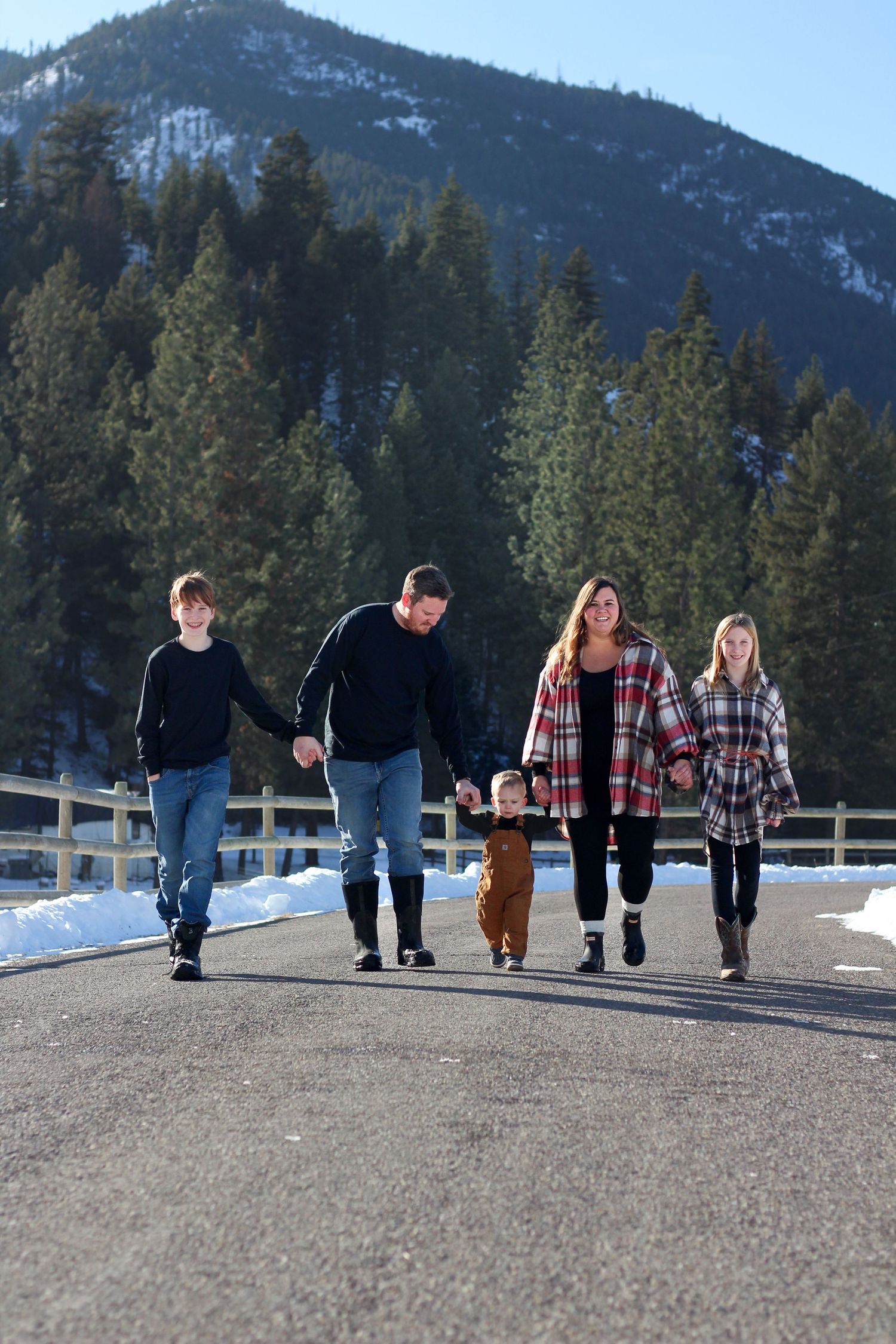 Missoula, Mt Family Portrait walking on road with snow around and mountains in the background
Kayla Sproles Photography 2025