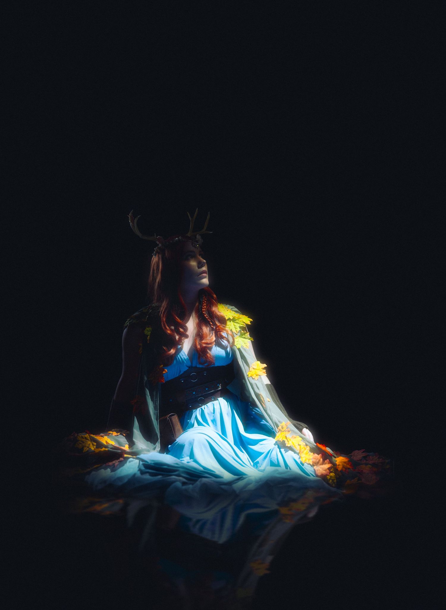 A figure lying down illuminated by dramatic blue and yellow lighting effects in a dark setting.