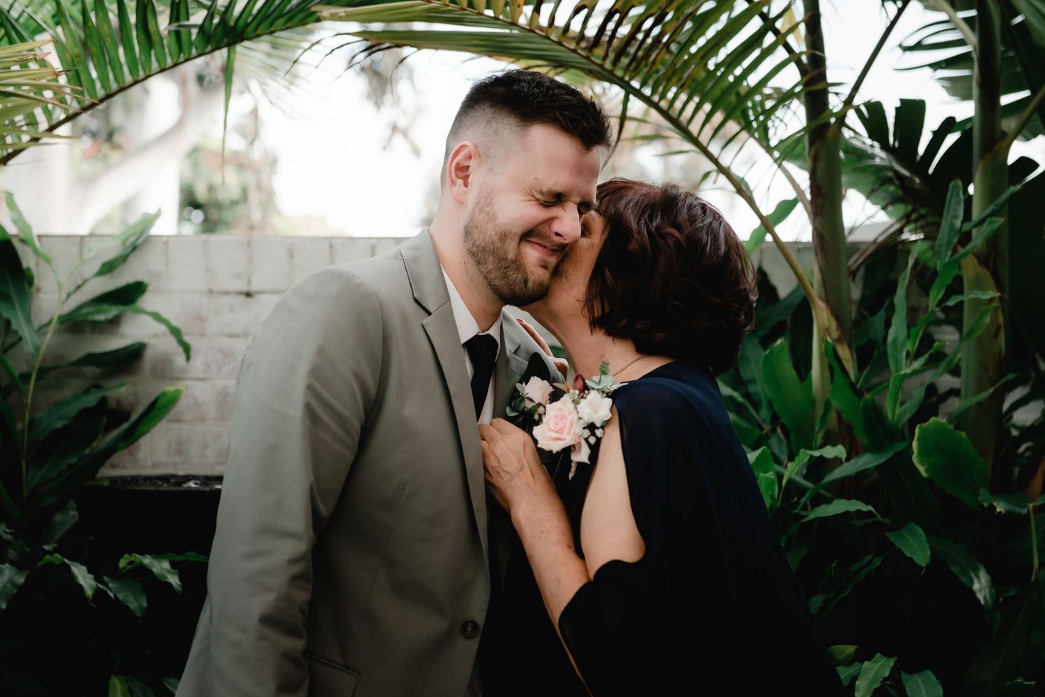 Tropical greenhouse setting with lush green plants creates romantic atmosphere.