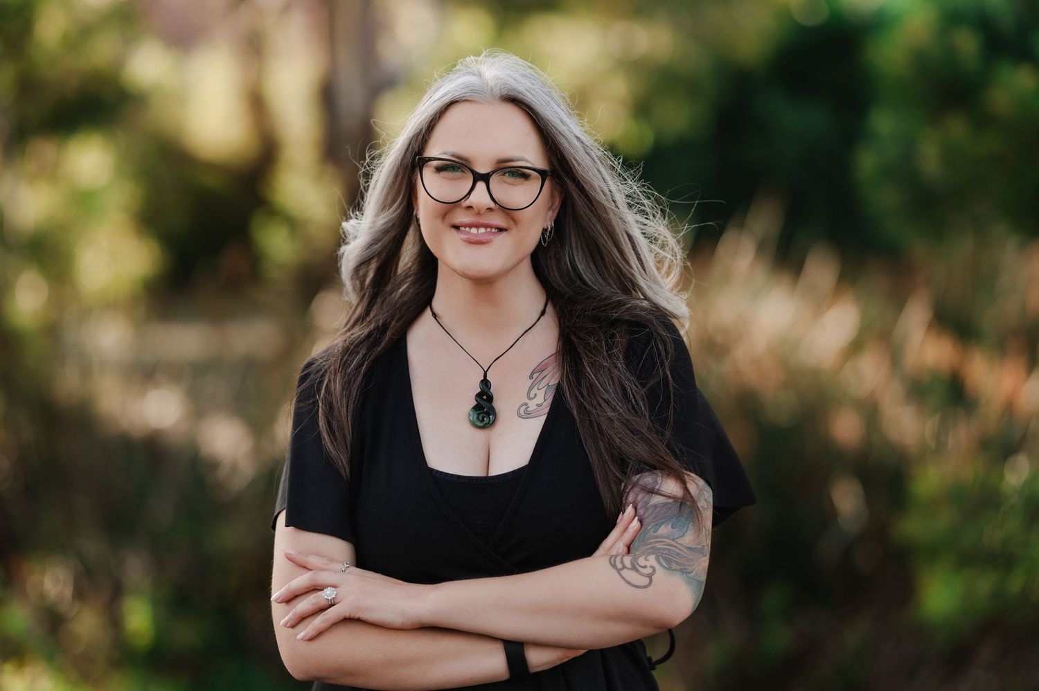 A woman in black poses outdoors in a series of casual portrait shots.