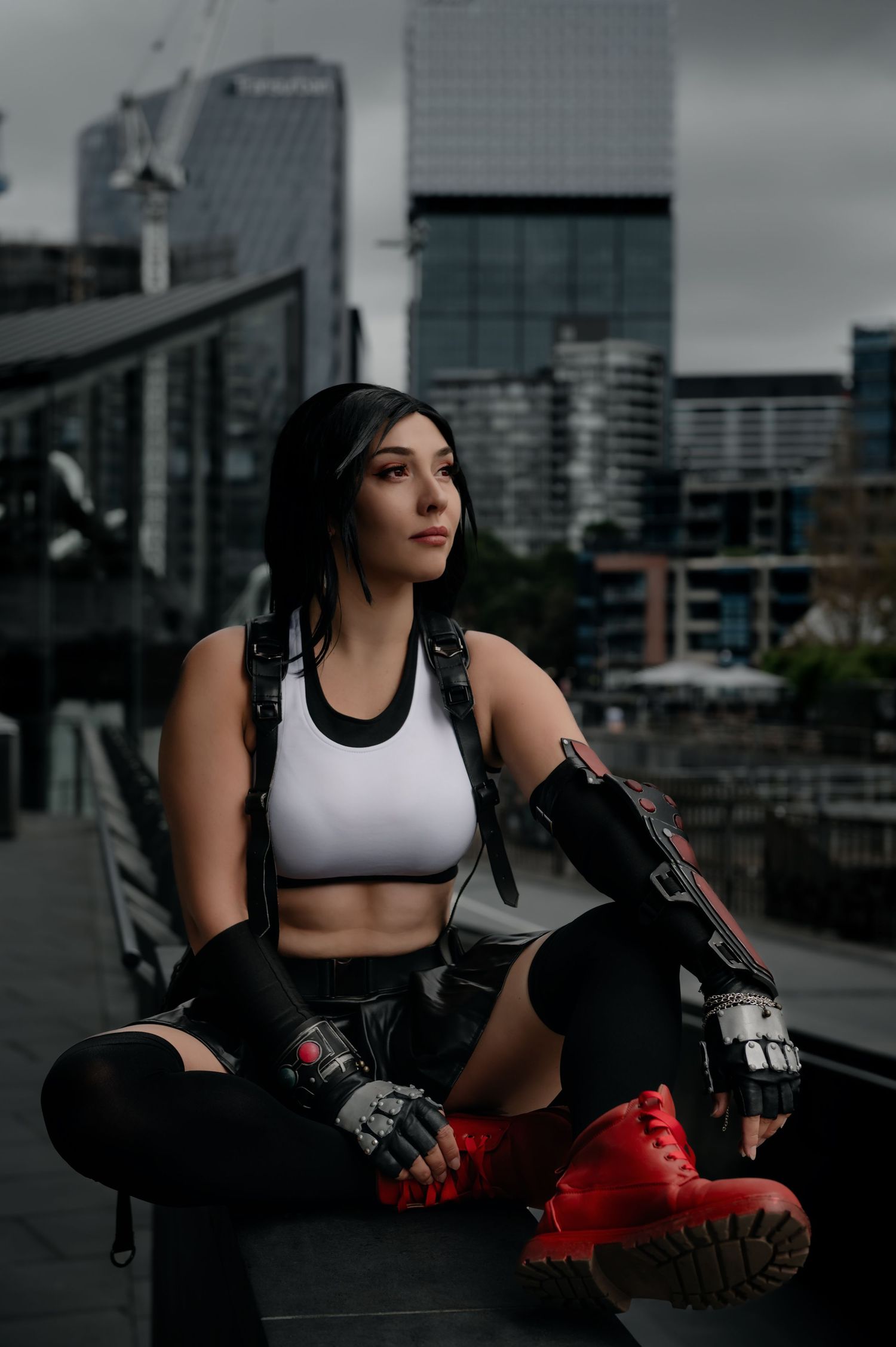 Urban cosplay portrait showcasing athletic wear against city skyline backdrop.