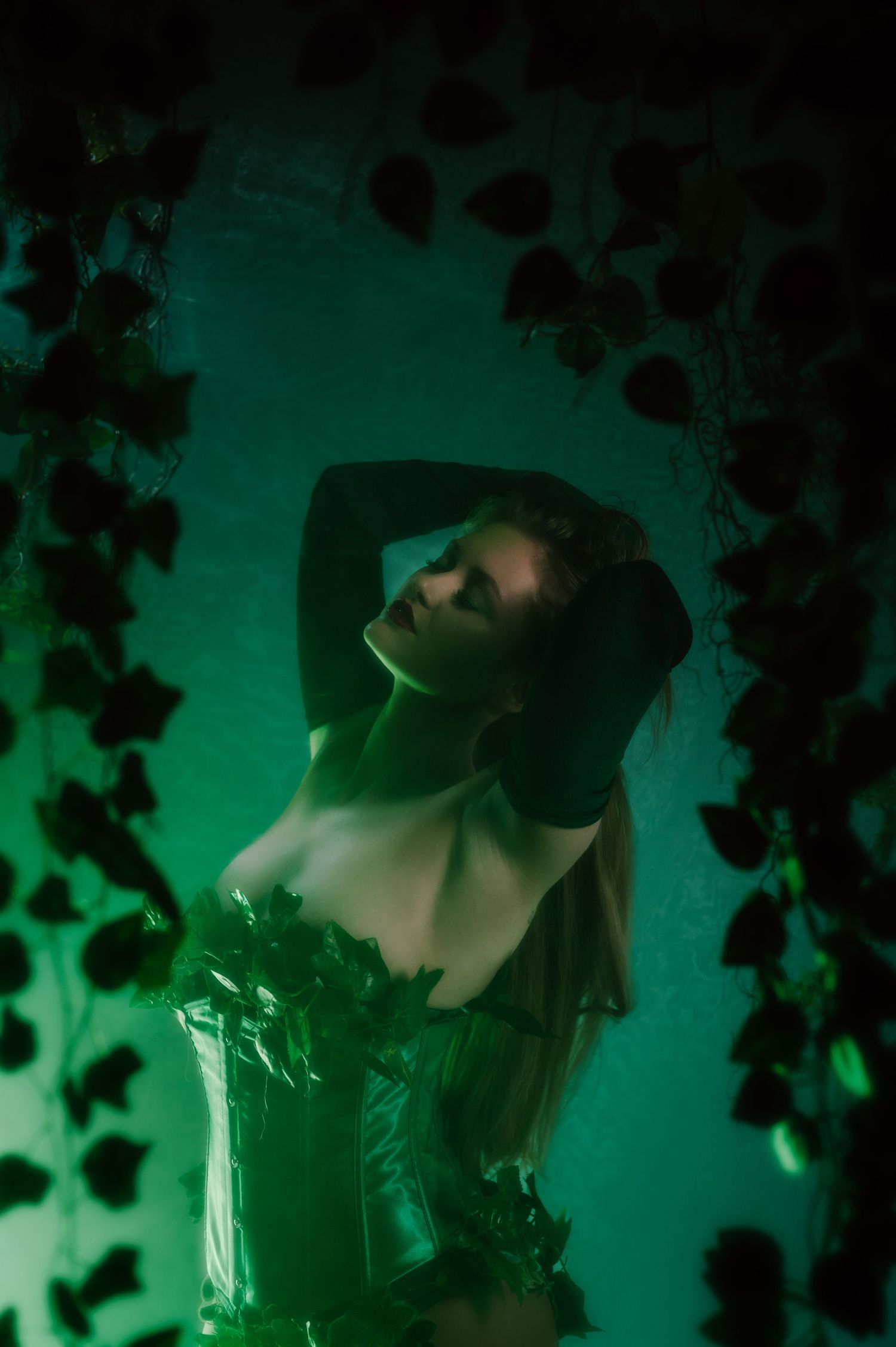 Artistic portrait series with green lighting and shadows creating a moody atmospheric effect.