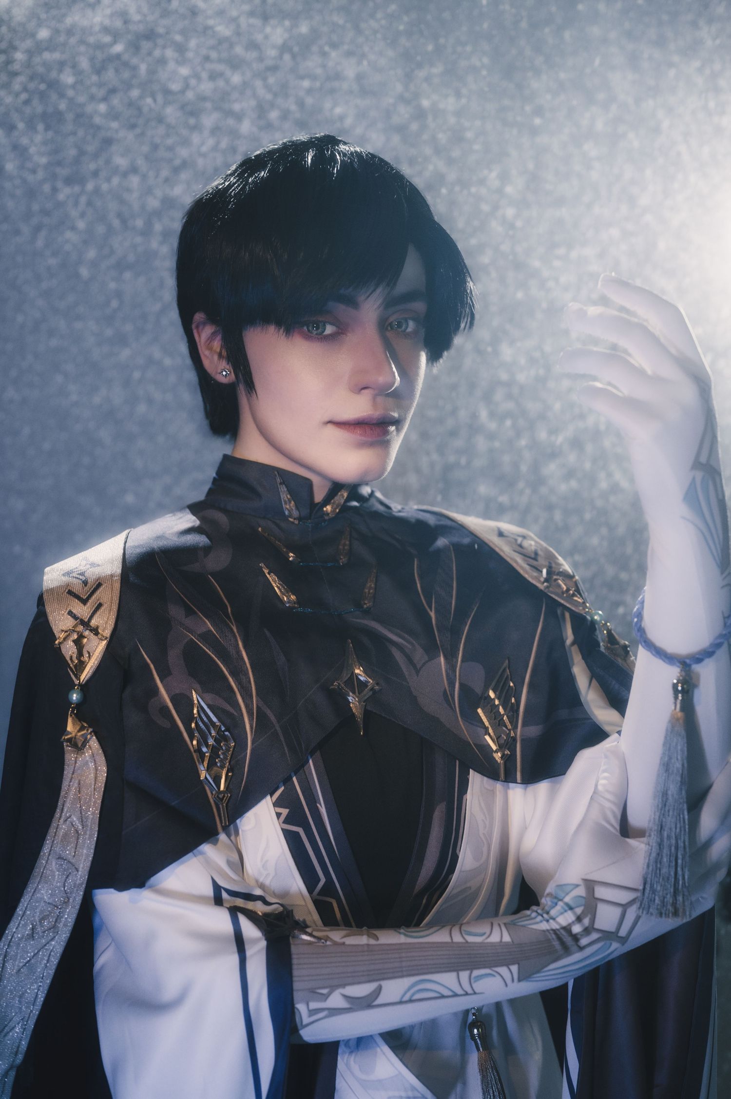 Fashion series featuring white gloves and detailed black costume in misty setting.
