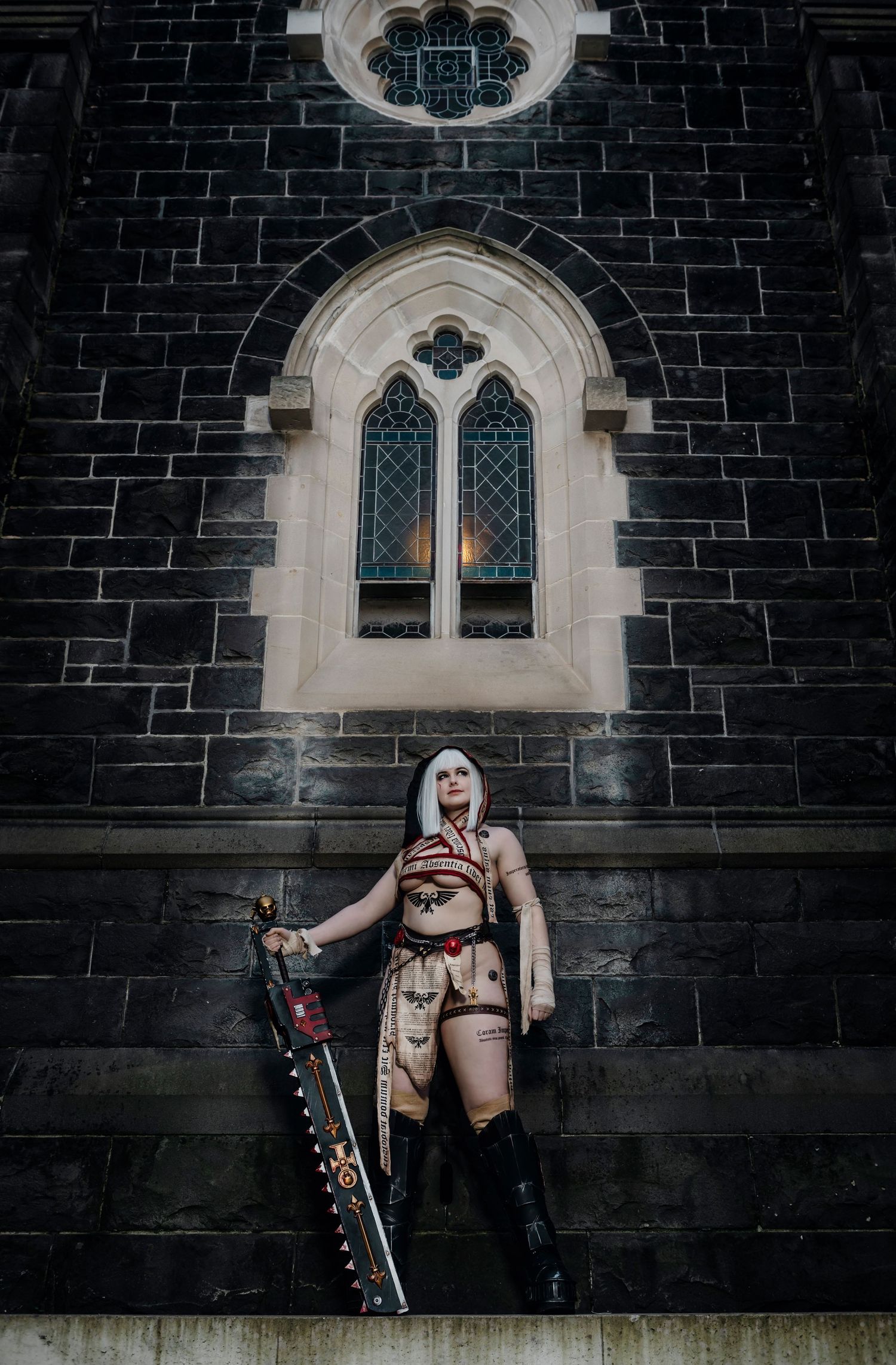 Gothic church windows frame a dramatic cosplay photoshoot scene.