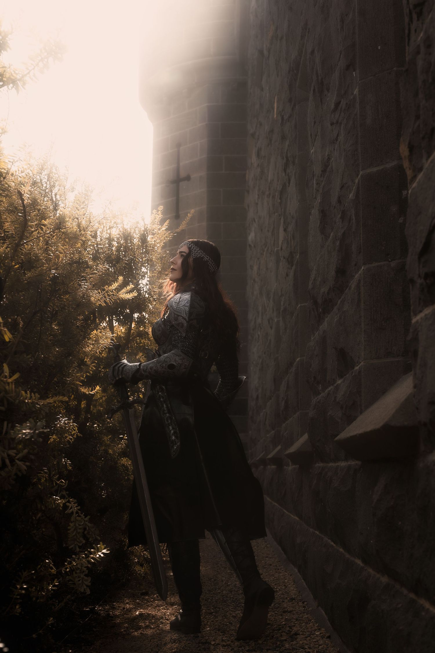Silhouetted figures engage in medieval combat against a misty castle backdrop.
