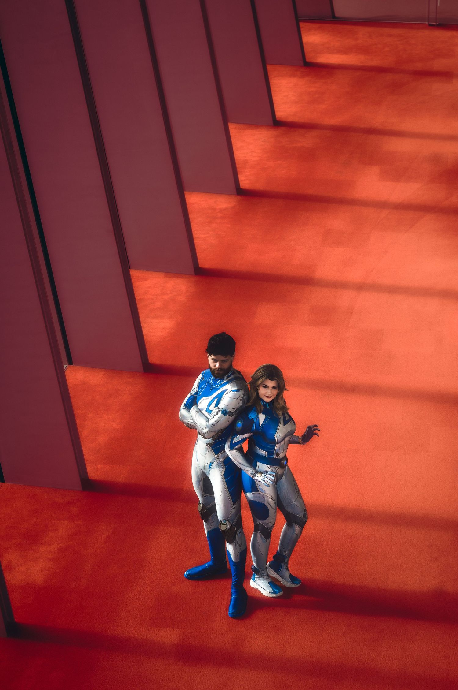 A cosplay photoshoot sequence showing dramatic poses on red-lit stairs.