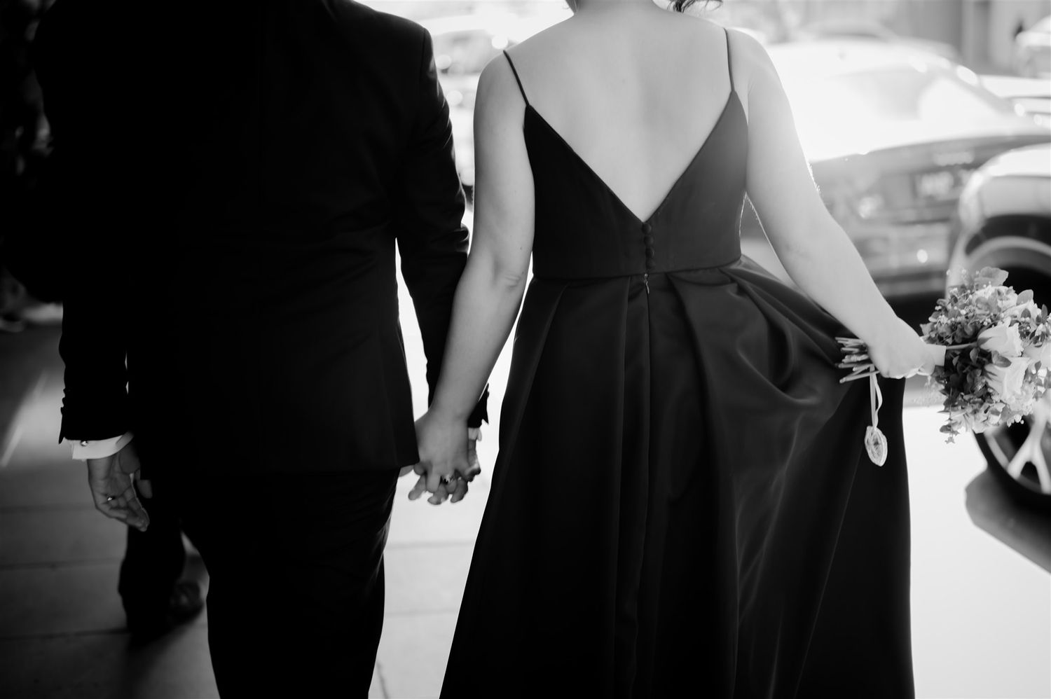 Formal event attendees in black attire shown in silhouette.