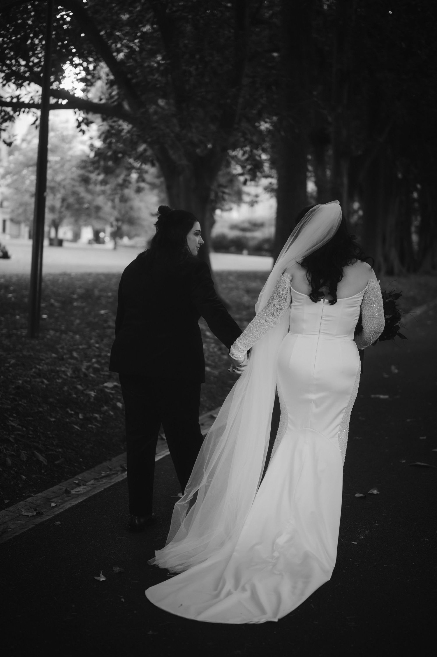 Black and white wedding photography in a wooded park setting.