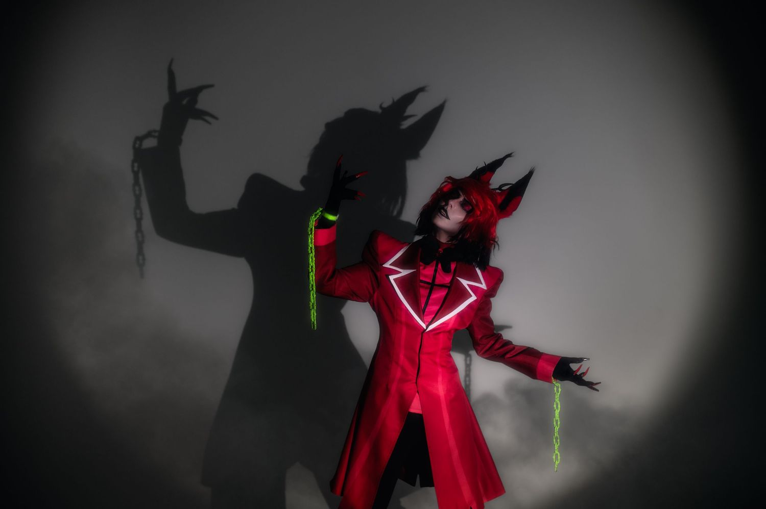 Dark silhouette figures performing dramatic poses against a shadowy background.