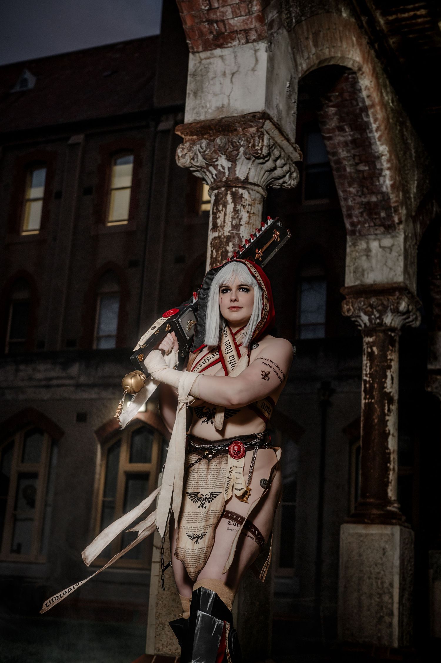 Dark atmospheric cosplay photoshoot in an abandoned industrial setting.