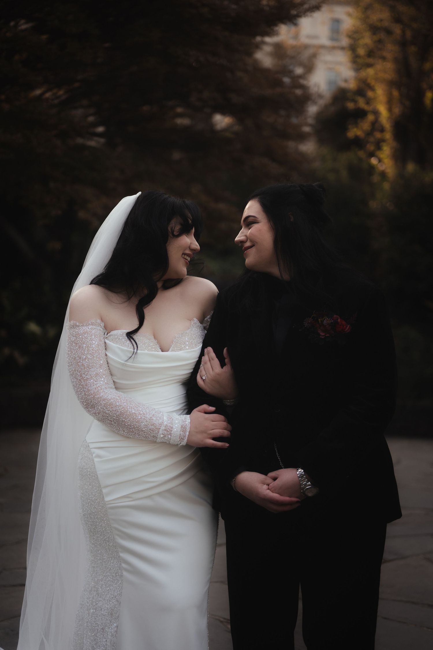 Intimate moment between couple in wedding attire during outdoor autumn photoshoot.