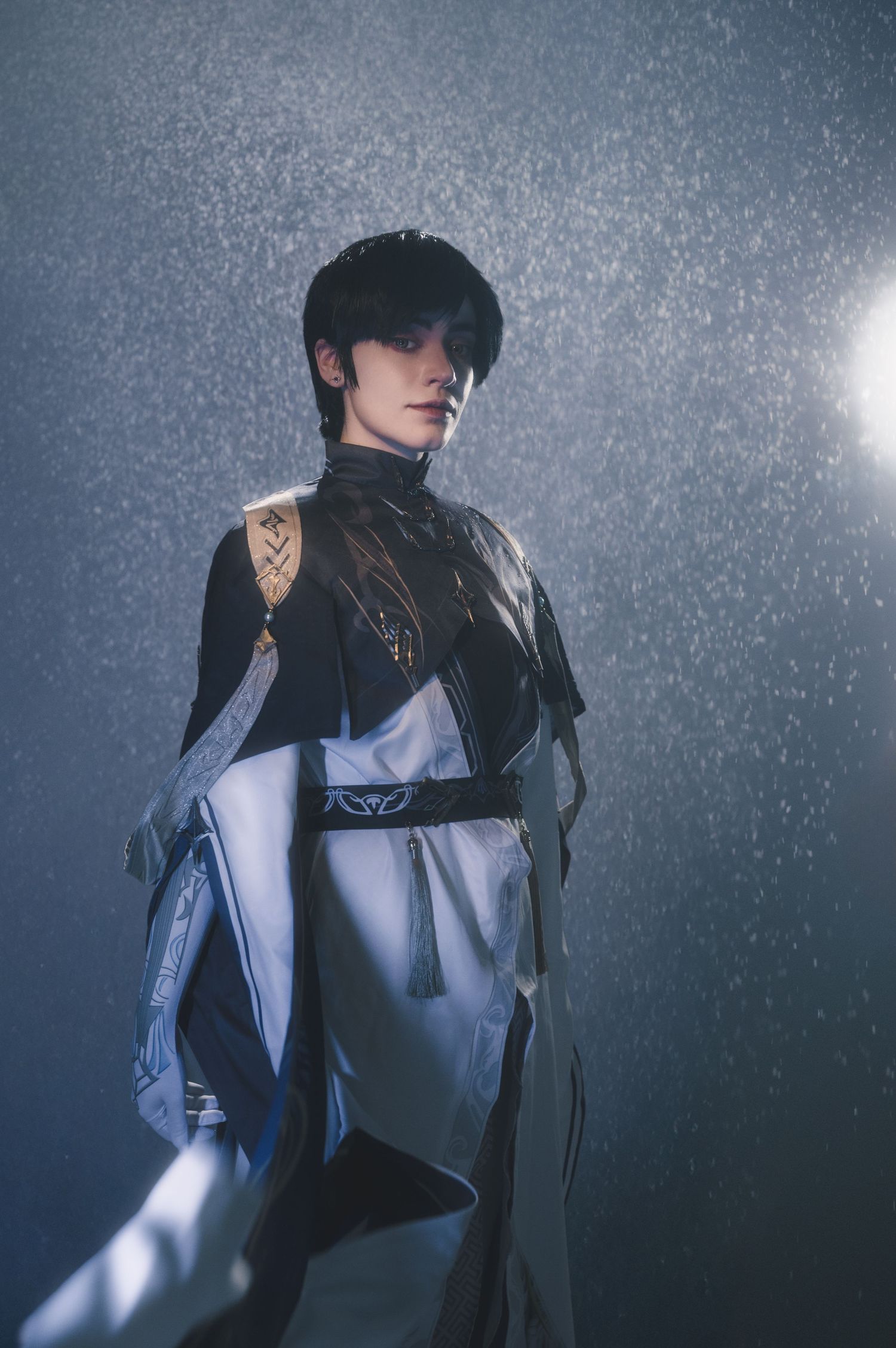 Moody fashion portrait featuring structured clothing and dramatic lighting effects.