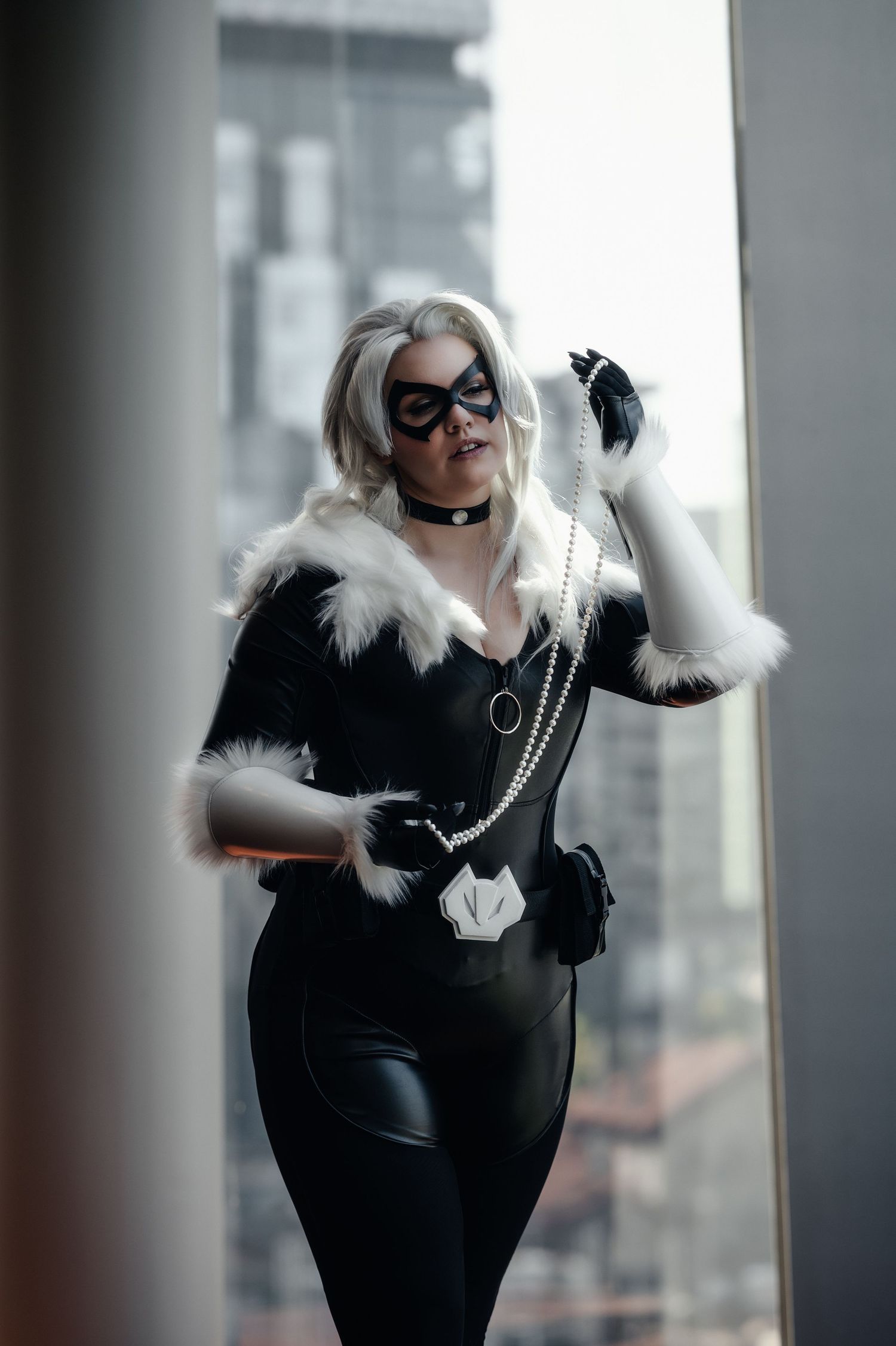 Dynamic cosplay poses captured between architectural columns with city backdrop.