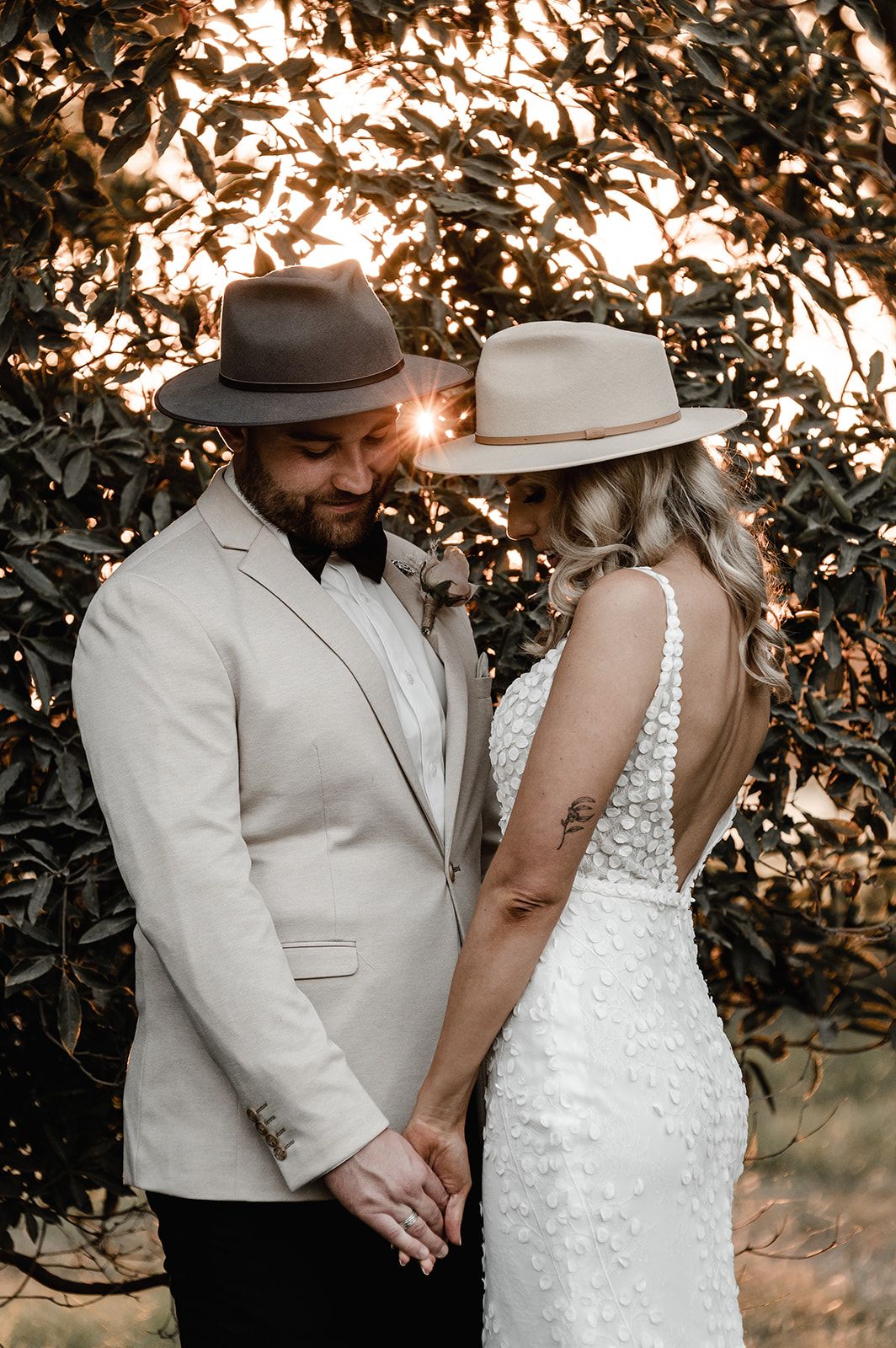 Intimate wedding photography with couple in rustic setting during golden hour.