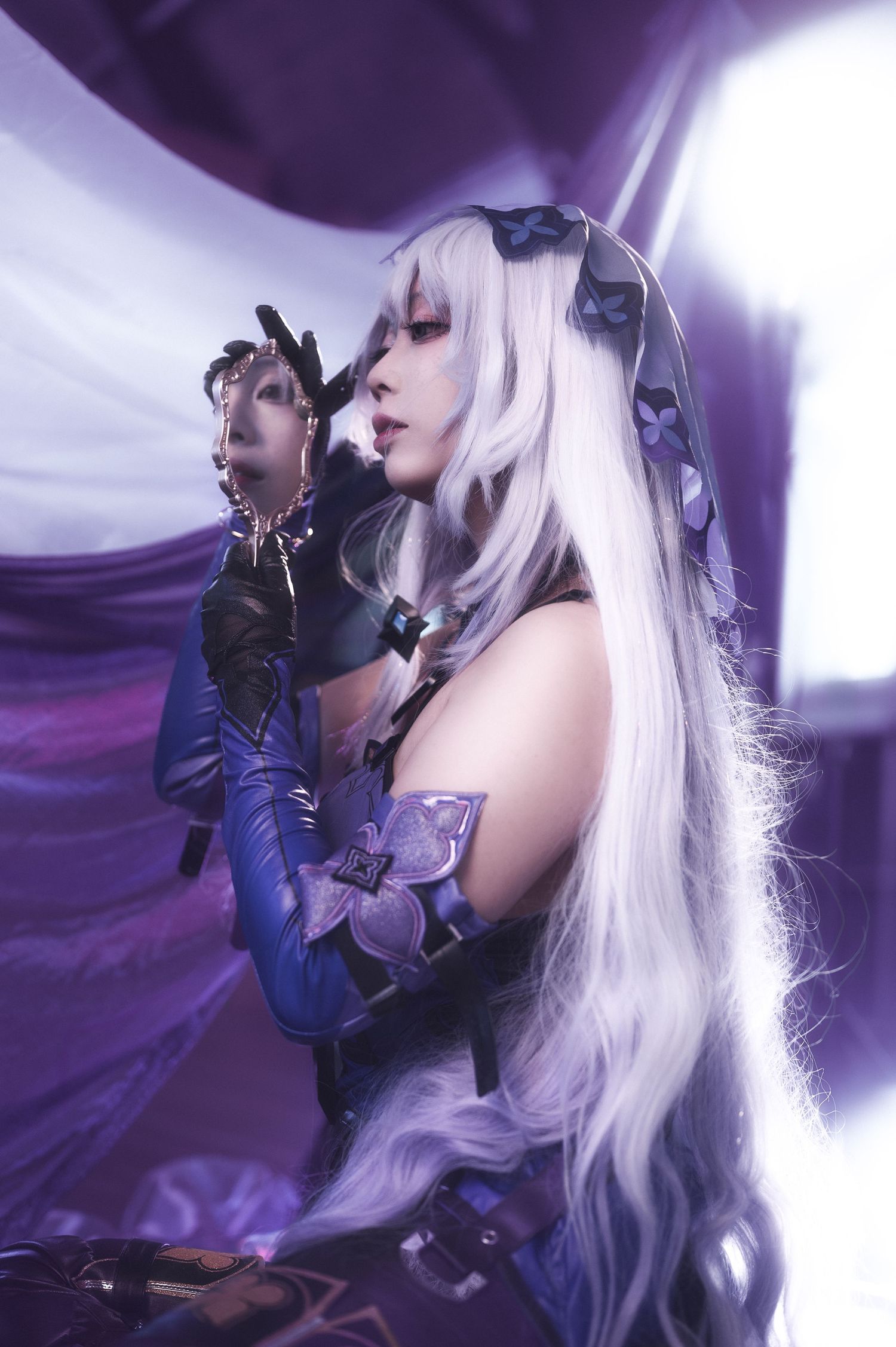 Fantasy cosplay portrait with purple lighting and flowing white hair.